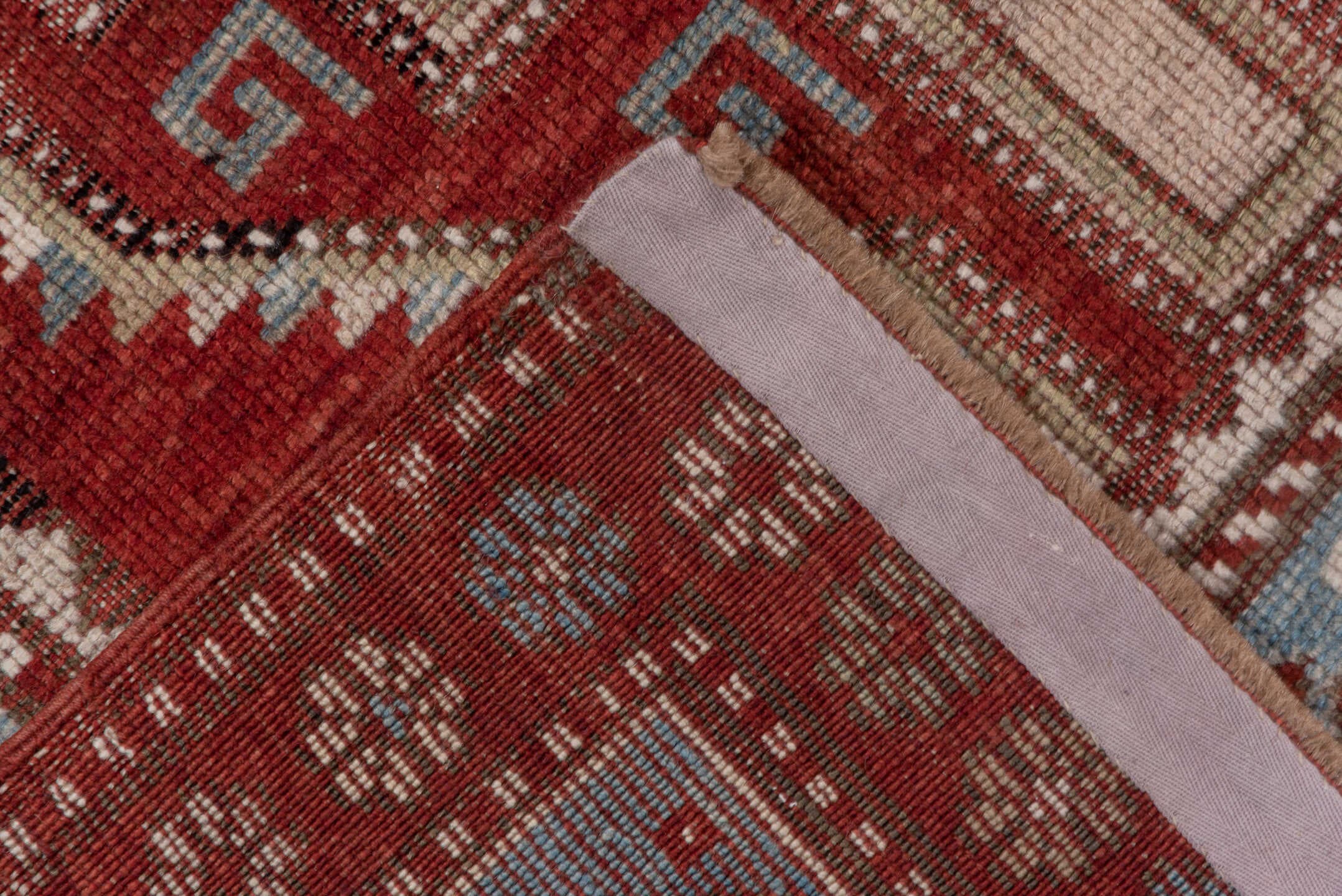 4' x 9' one-of-a-kind handmade antique Kazak runner rug. Color palette: rust, ivory, soft blue, brick, taupe, burgundy