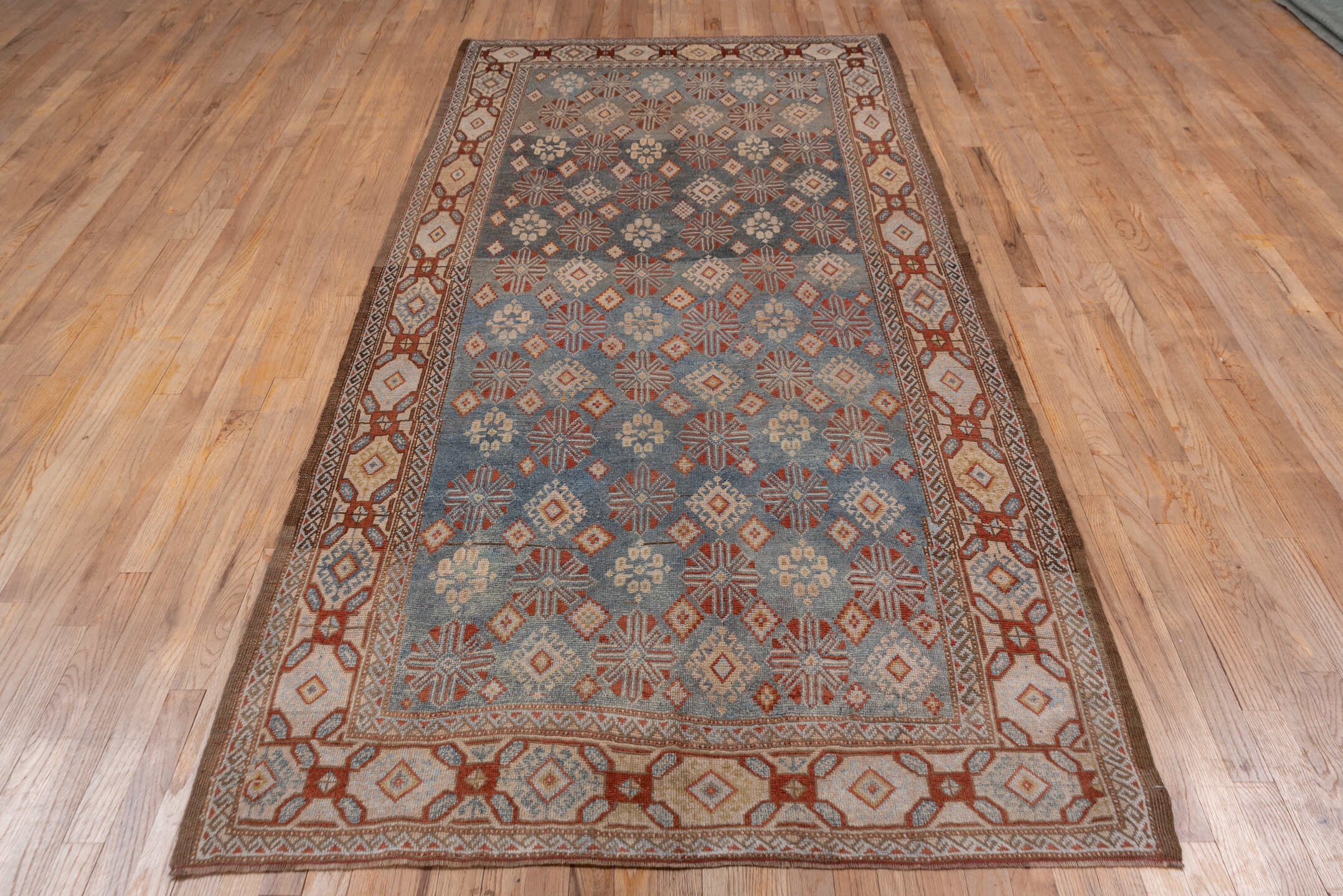 4' x 9' one-of-a-kind handmade antique Caucasian runner rug. Color palette: blue, ivory, rust, taupe, slate, camel