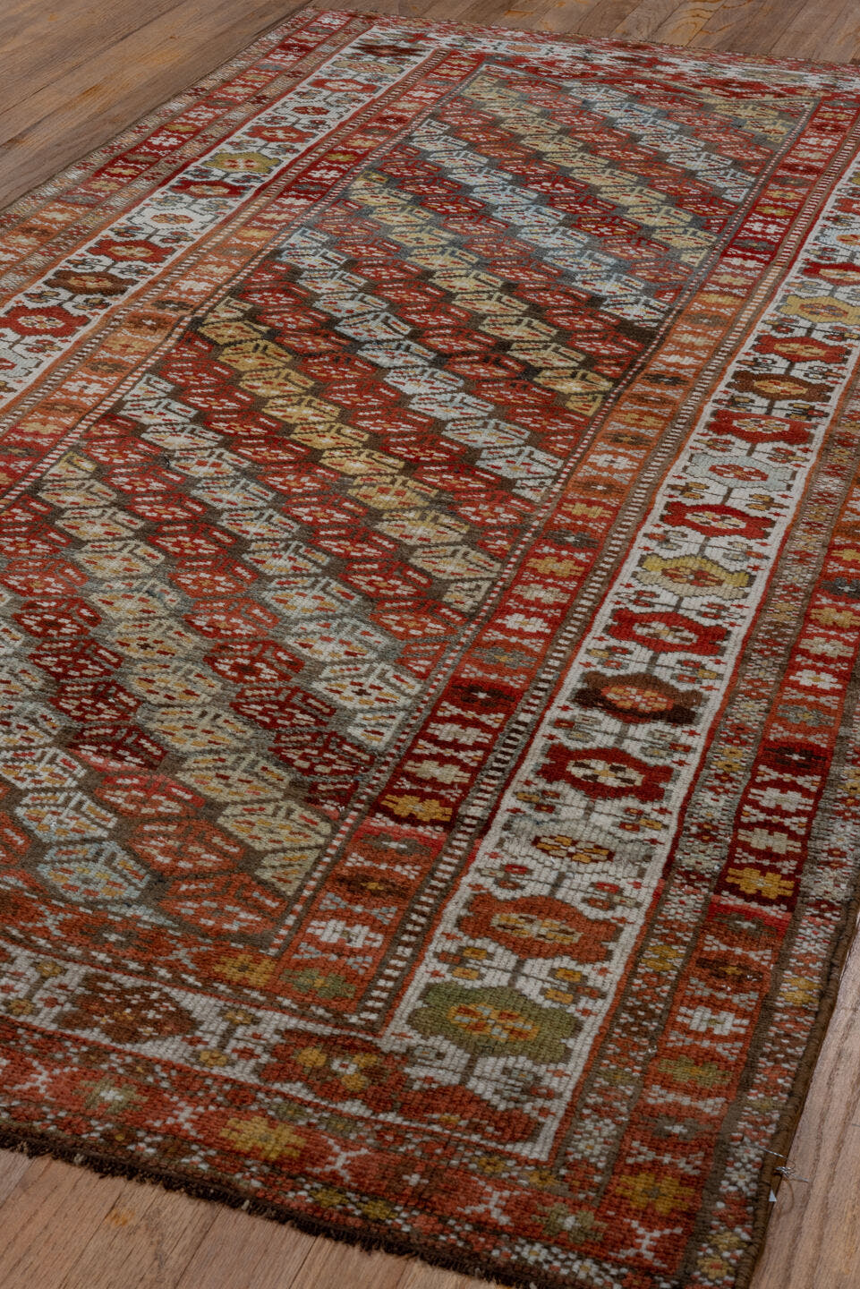 3' x 7' one-of-a-kind handmade antique Kurd rug. Color palette: rust, ivory, sky blue, camel, olive, brown, brick, slate