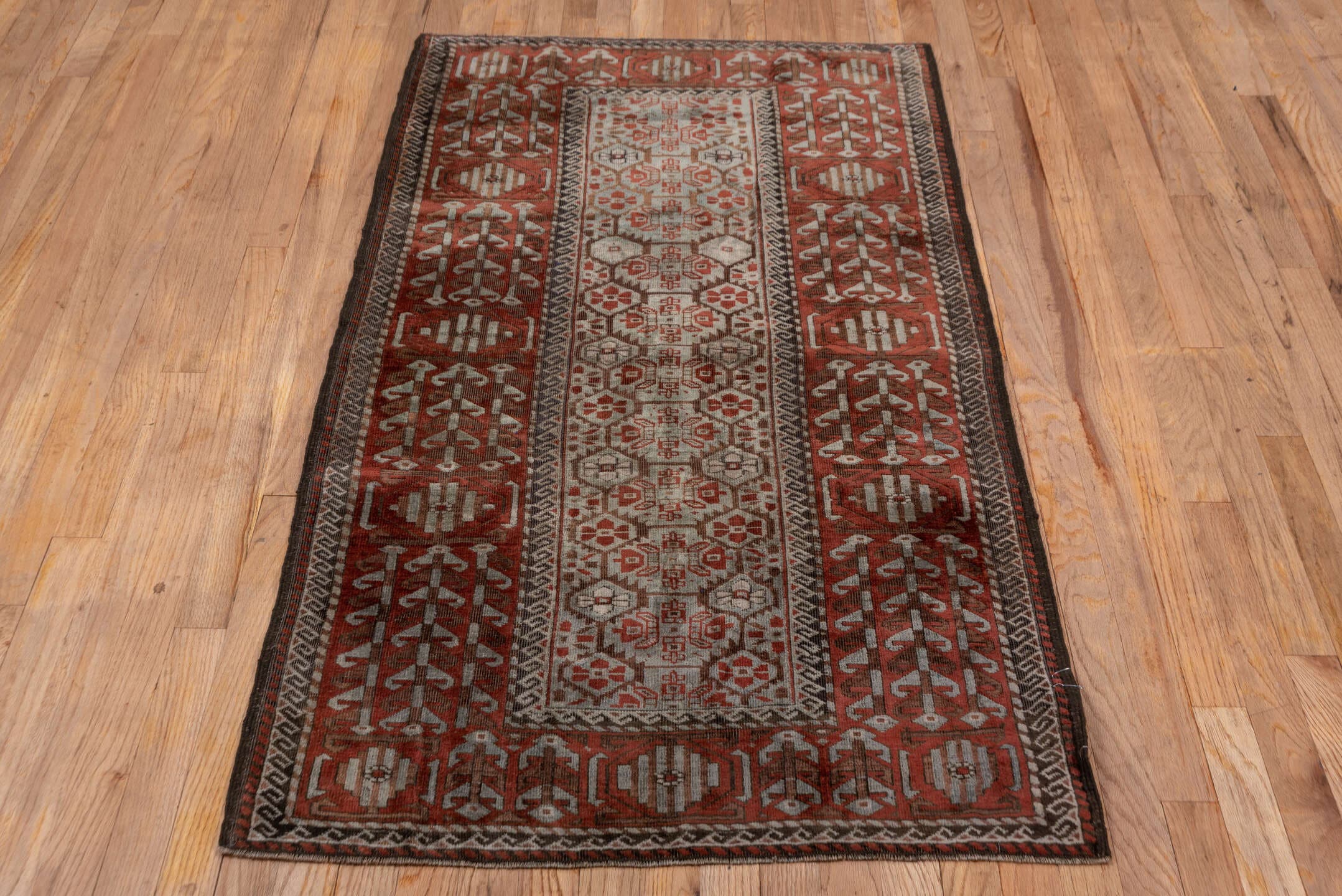 2' x 5' one-of-a-kind handmade antique Belouch small size rug. Color palette: rust, ivory, brown, camel, charcoal