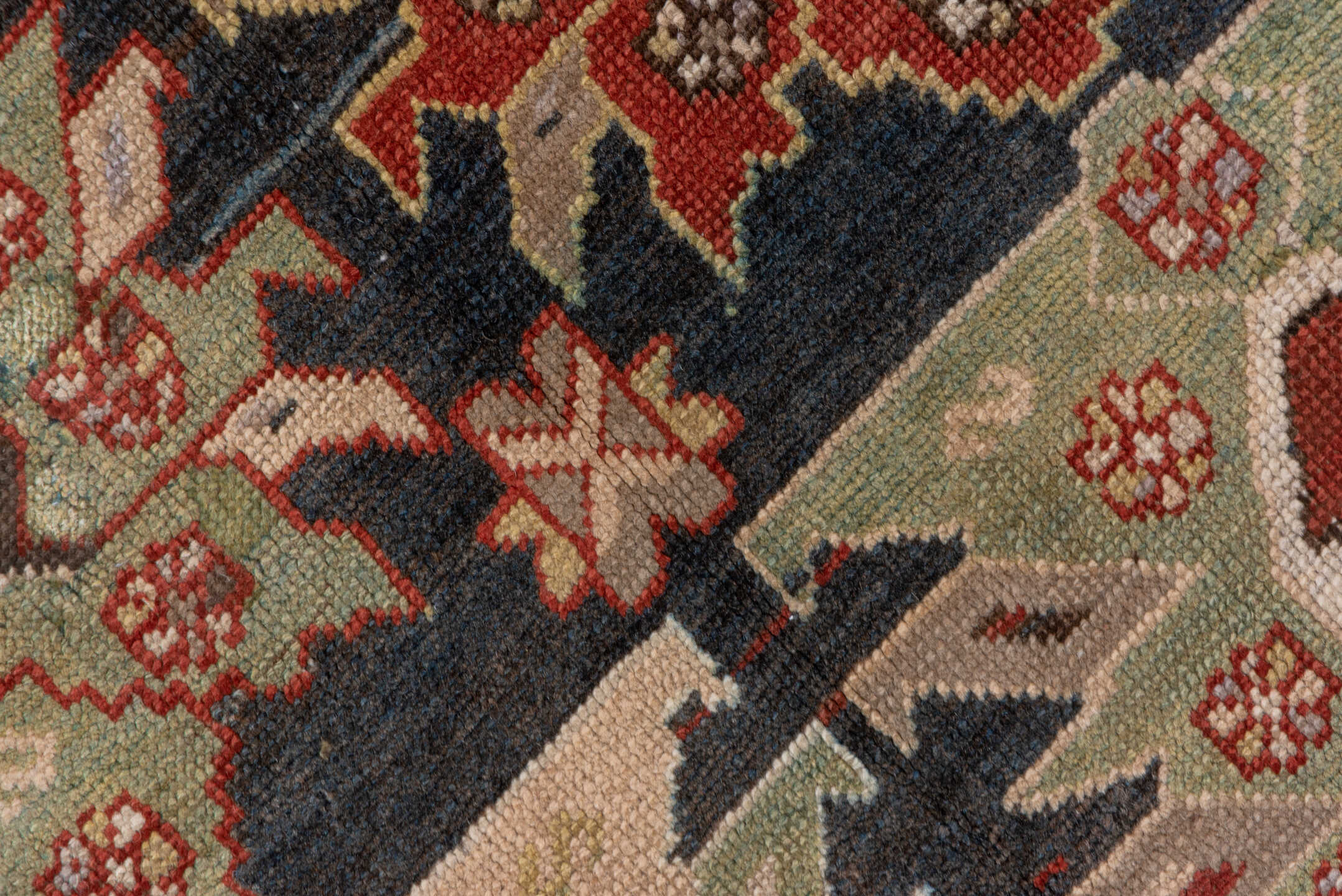 4' x 8' one-of-a-kind handmade antique Caucasian rug. Color palette: ivory, rust, brick, slate, sky_blue, camel, charcoal
