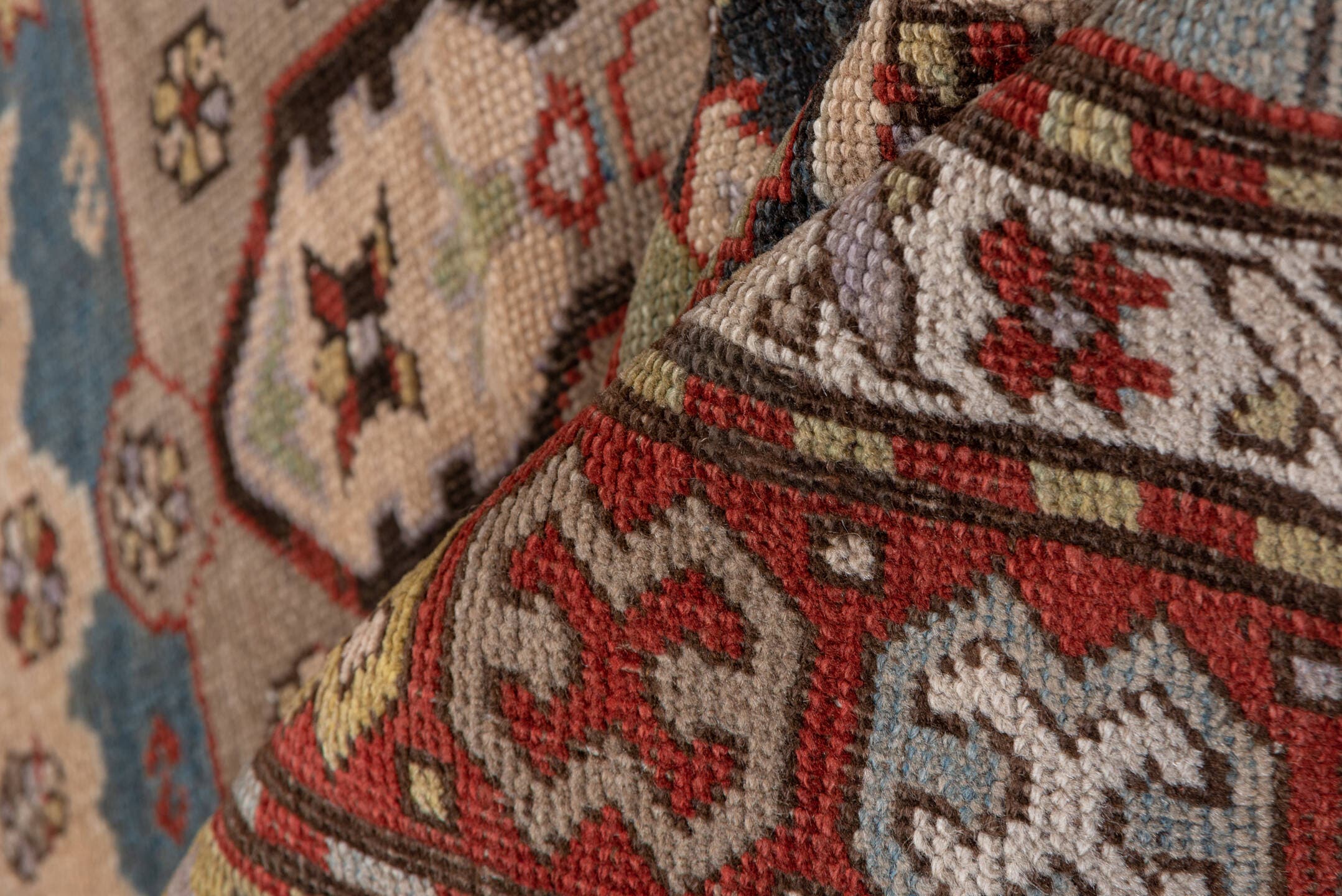 4' x 8' one-of-a-kind handmade antique Caucasian rug. Color palette: ivory, rust, brick, slate, sky_blue, camel, charcoal