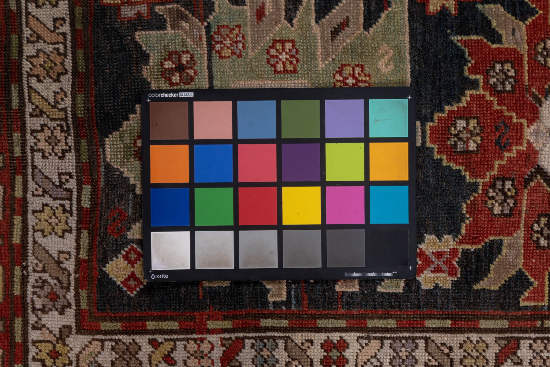 4' x 8' one-of-a-kind handmade antique Caucasian rug. Color palette: ivory, rust, brick, slate, sky_blue, camel, charcoal