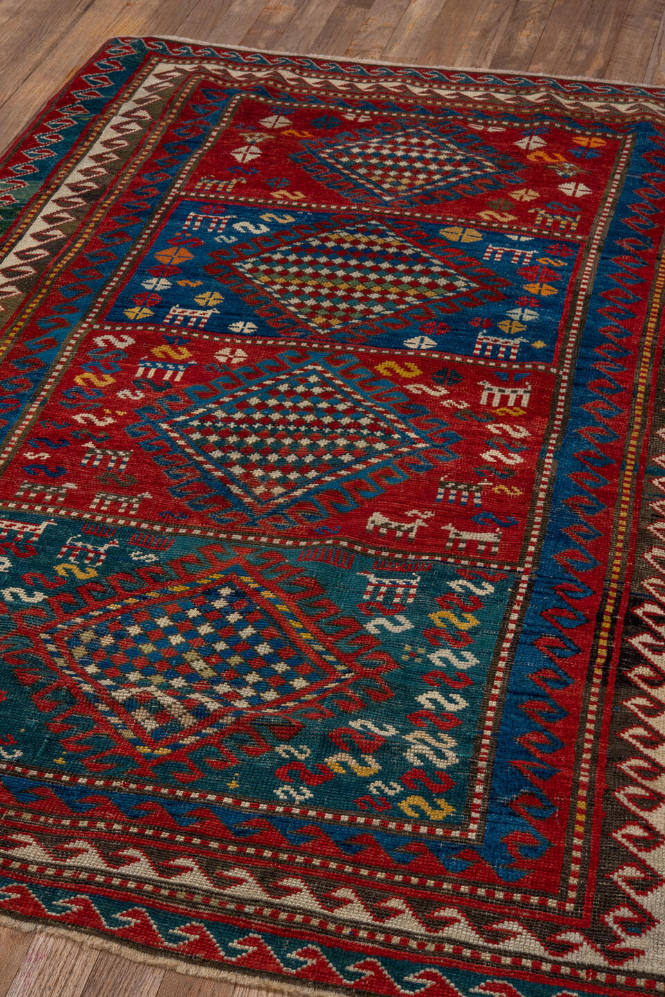 3' x 5' one-of-a-kind handmade antique Caucasian small size rug. Color palette: red, turquoise, ivory, blue, burgundy, camel