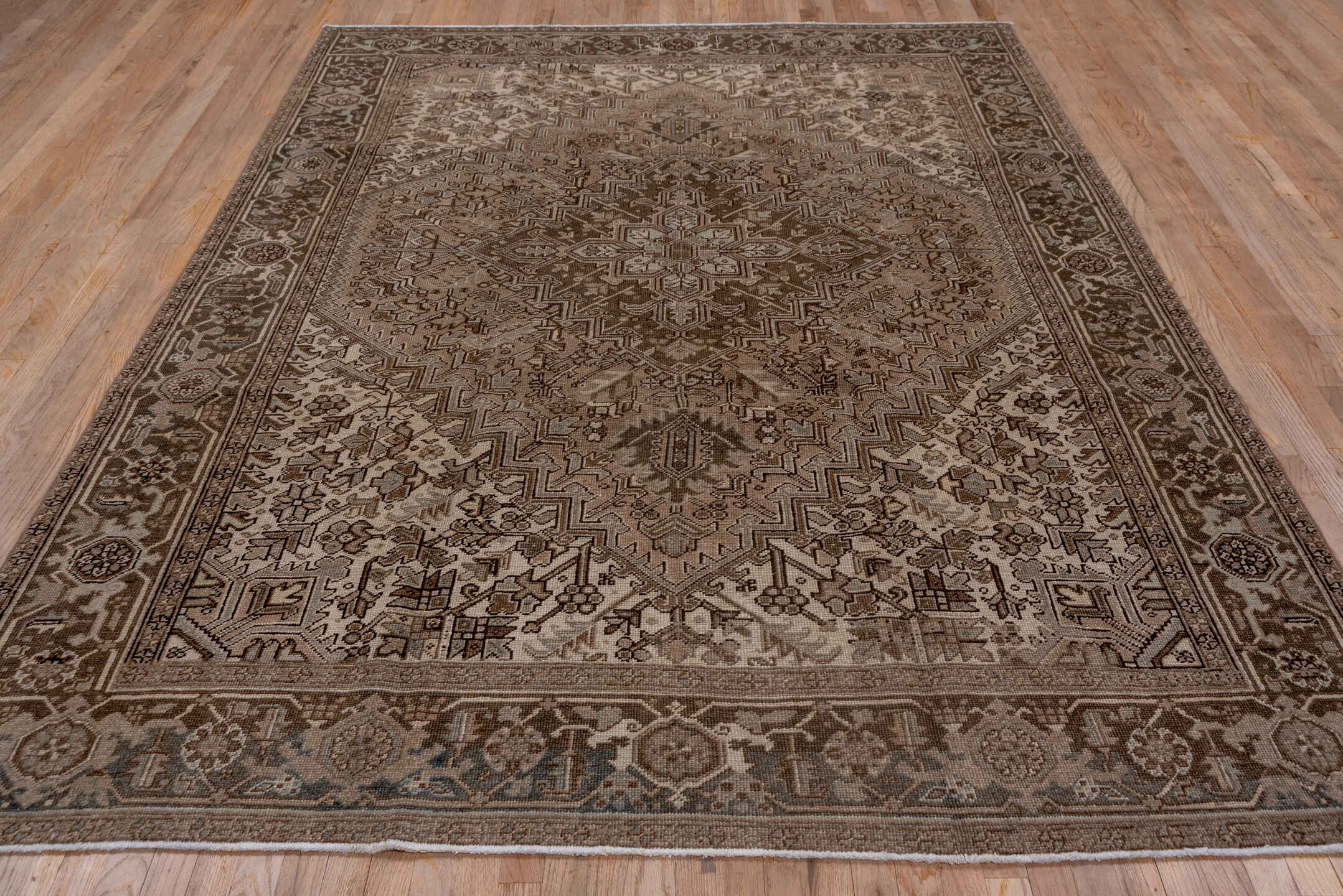 7' x 9' one-of-a-kind handmade vintage Heriz rug. Color palette: taupe, brown, ivory, charcoal, camel, greige, beige, gray