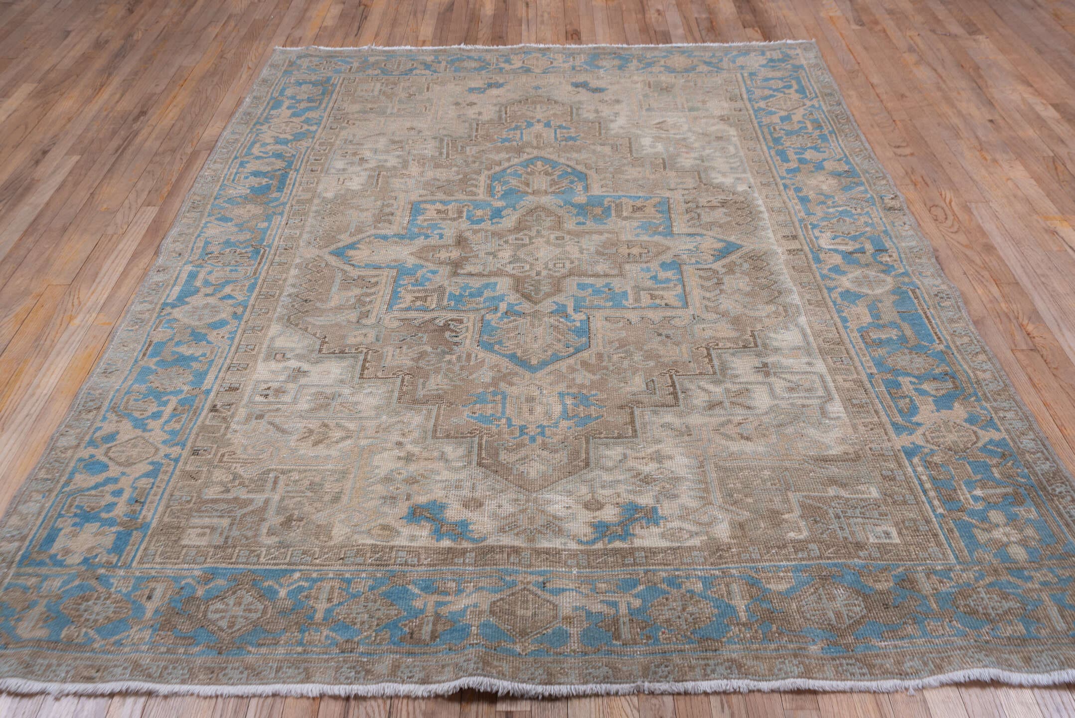 6' x 9' one-of-a-kind handmade antique Heriz medium size rug. Color palette: ivory, taupe, sky blue, beige, camel