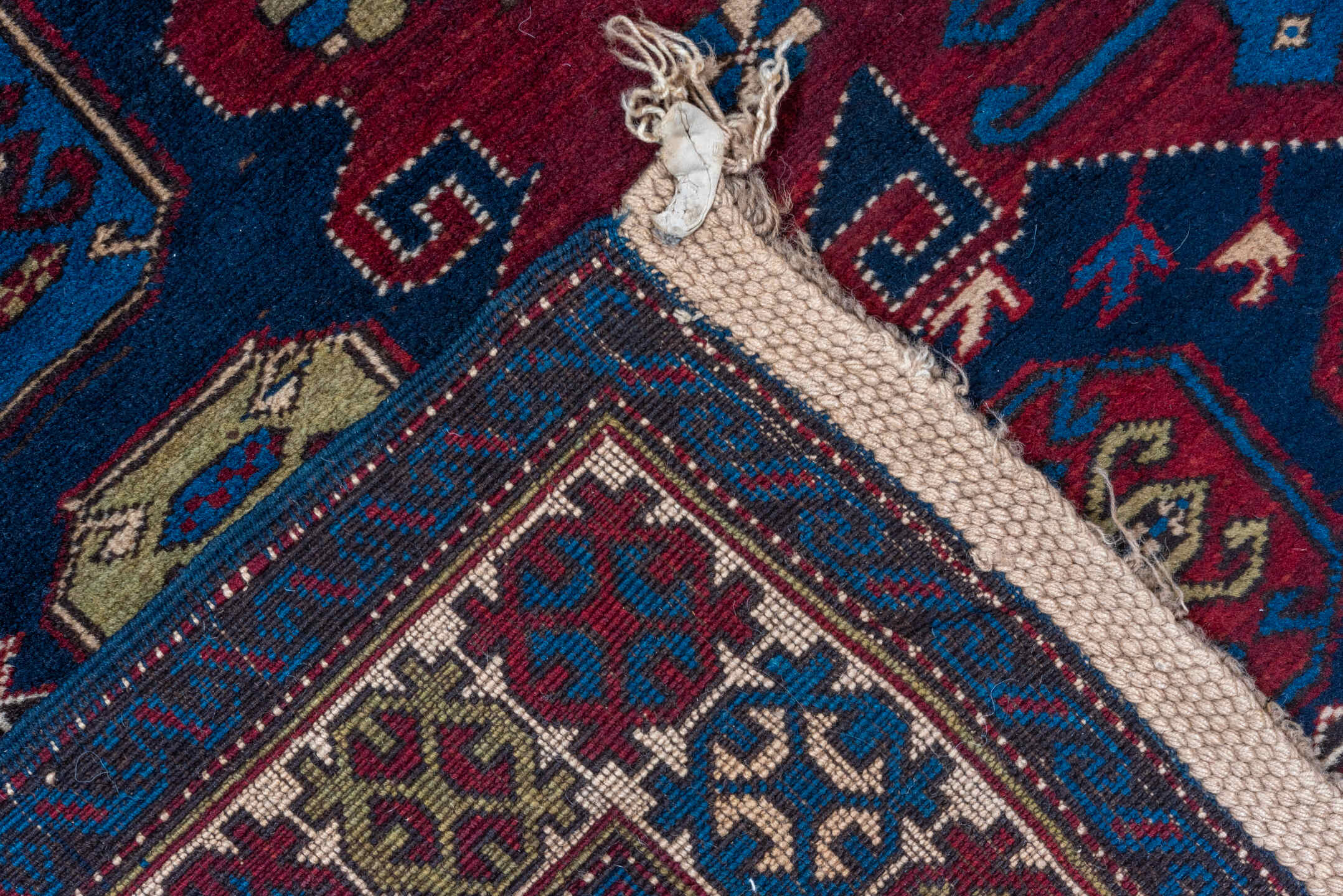 4' x 7' one-of-a-kind handmade antique Caucasian rug. Color palette: navy, crimson, ivory, cobalt, burgundy, camel, saffron