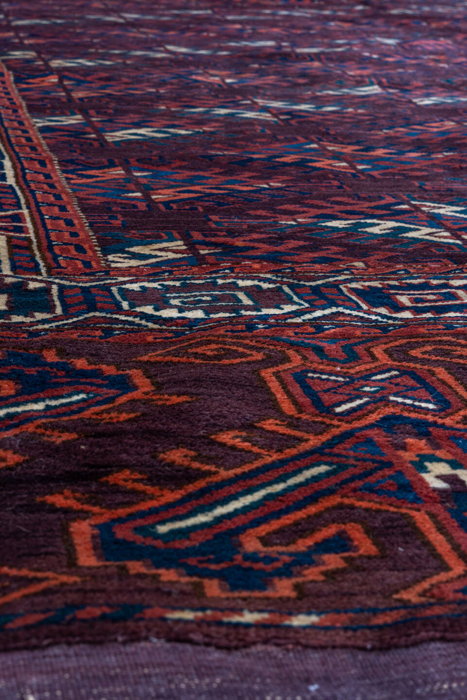 6' x 10' one-of-a-kind handmade vintage Yamoud large size rug. Color palette: burgundy, navy, rust, ivory, crimson, indigo