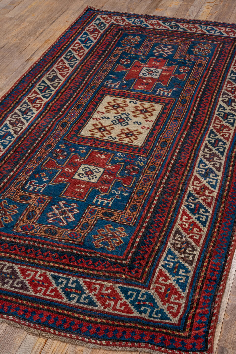 3' x 6' one-of-a-kind handmade antique Kazak runner rug. Color palette: blue, ivory, red, navy, rust, teal, brown