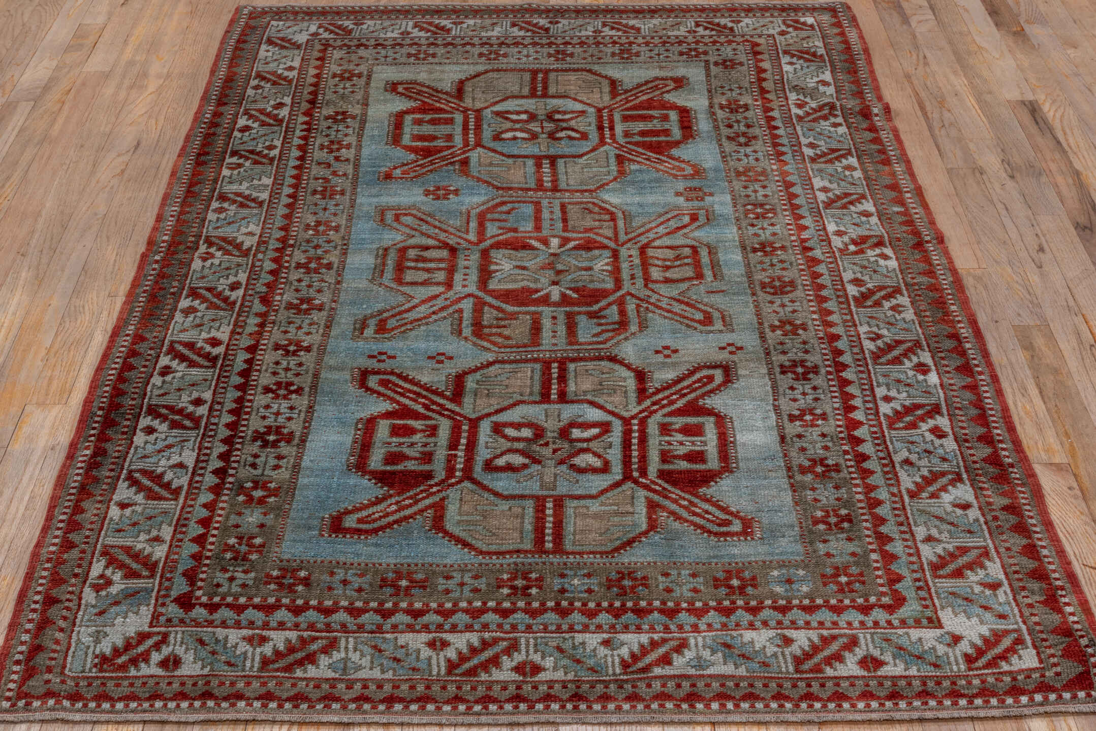 4' x 7' one-of-a-kind handmade antique Kazak rug. Color palette: rust, ivory, sky blue, taupe, brick, camel, terracotta