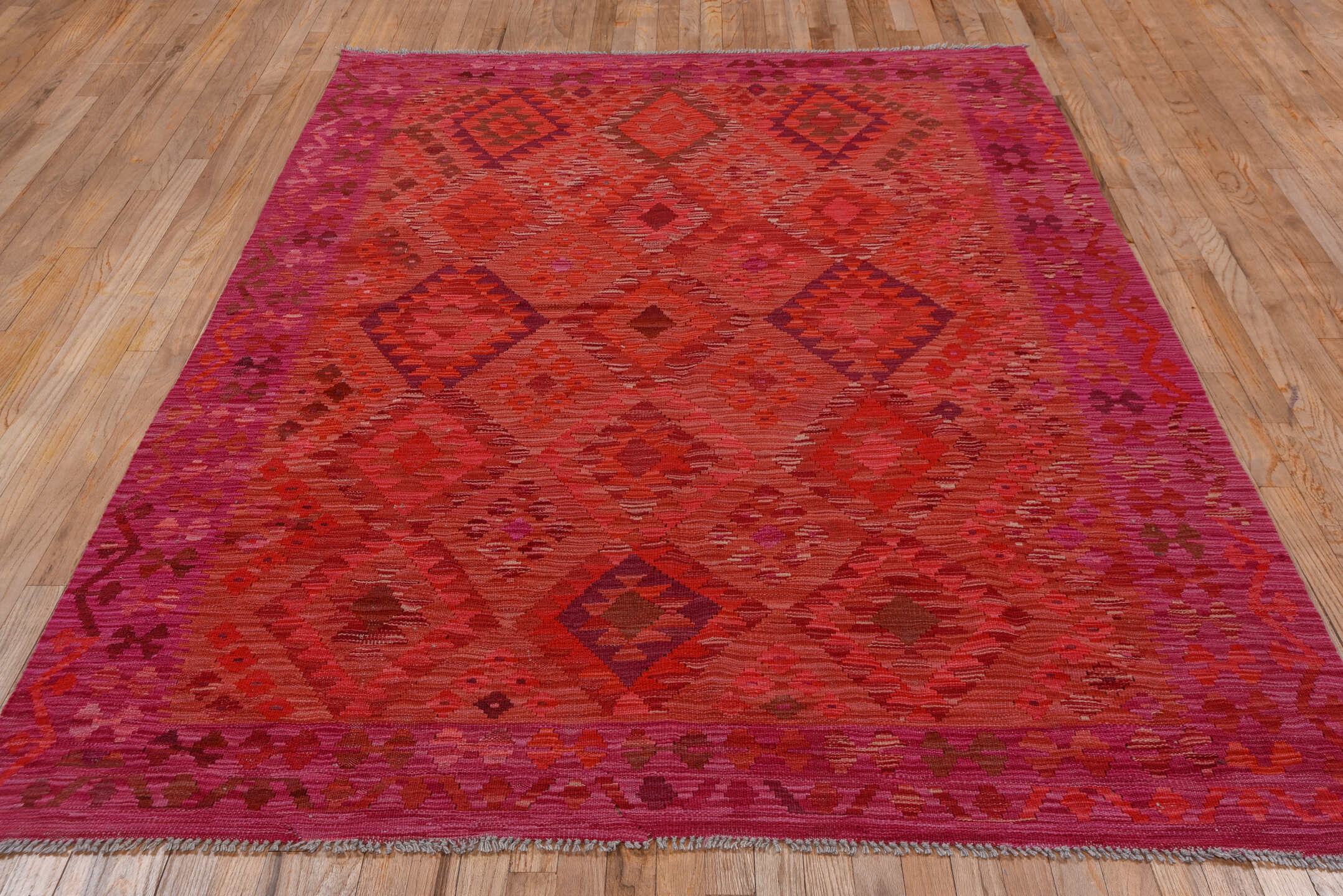 5' x 8' one-of-a-kind handmade vintage Kilim medium size rug. Color palette: magenta, crimson, fuchsia, rose, burgundy