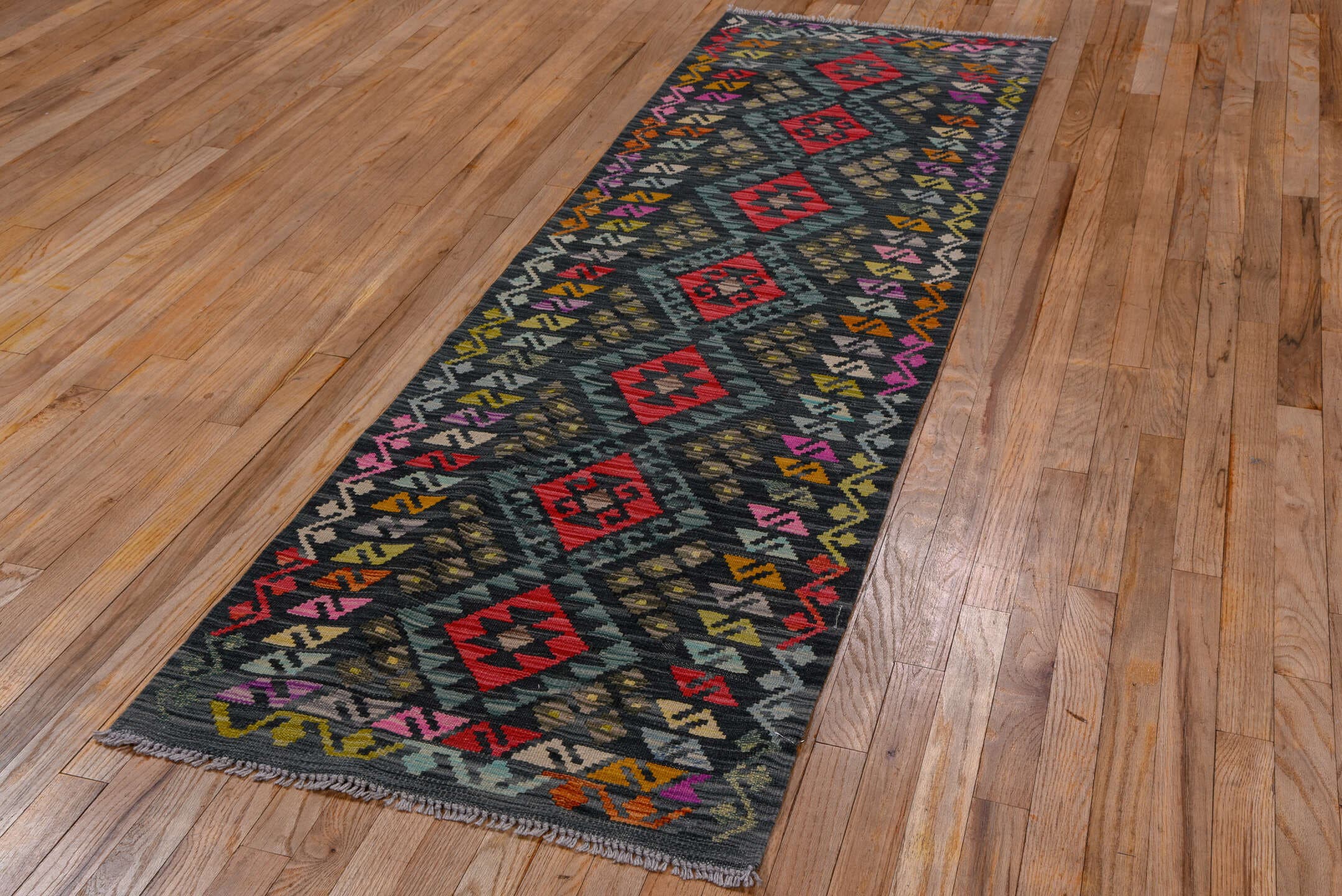 2' x 8' one-of-a-kind handmade vintage Kilim runner rug. Color palette: charcoal, teal, crimson, saffron, ivory, pink, taupe