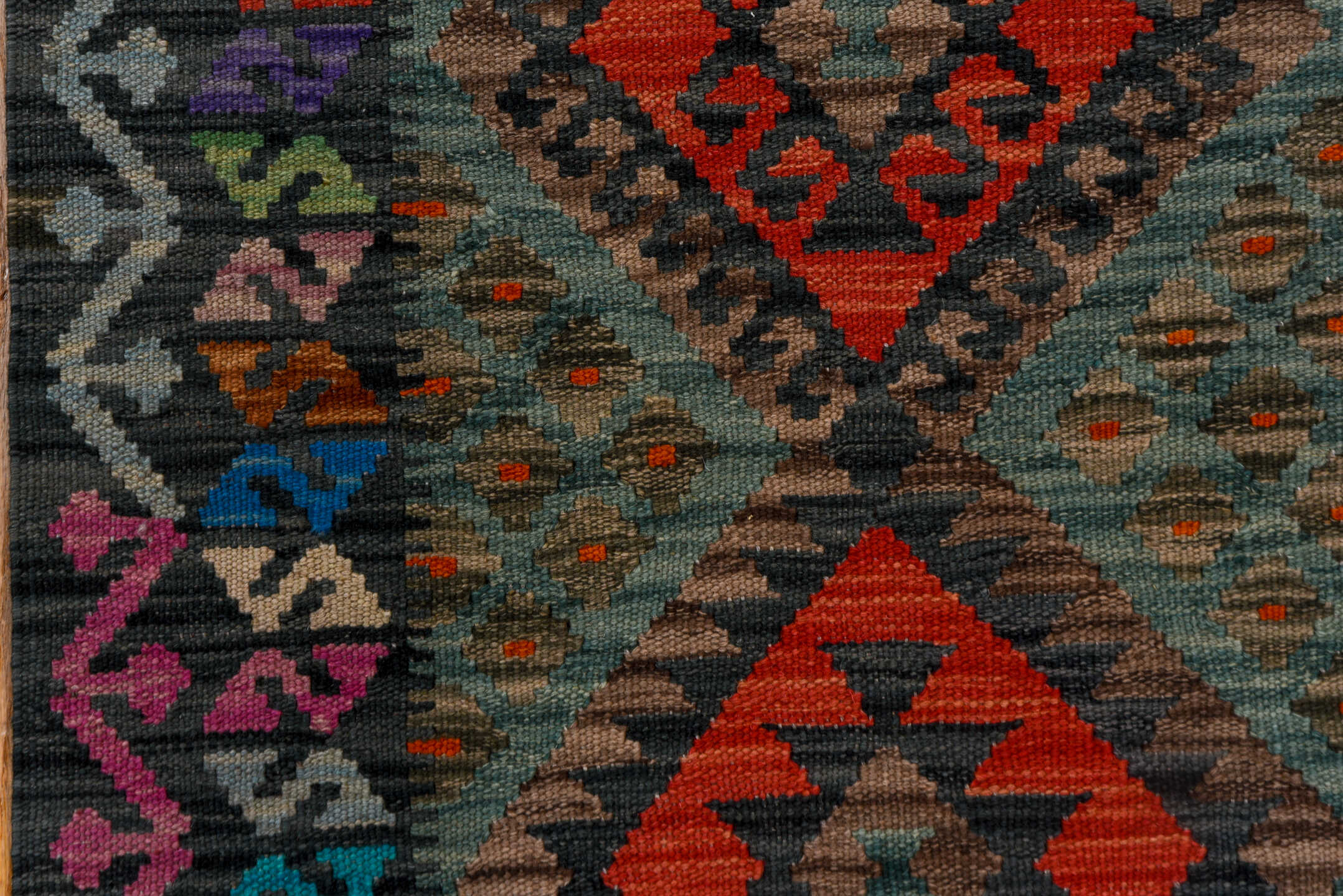 2' x 9' one-of-a-kind handmade vintage Kilim runner rug. Color palette: charcoal, crimson, turquoise, coral, ivory, lavender