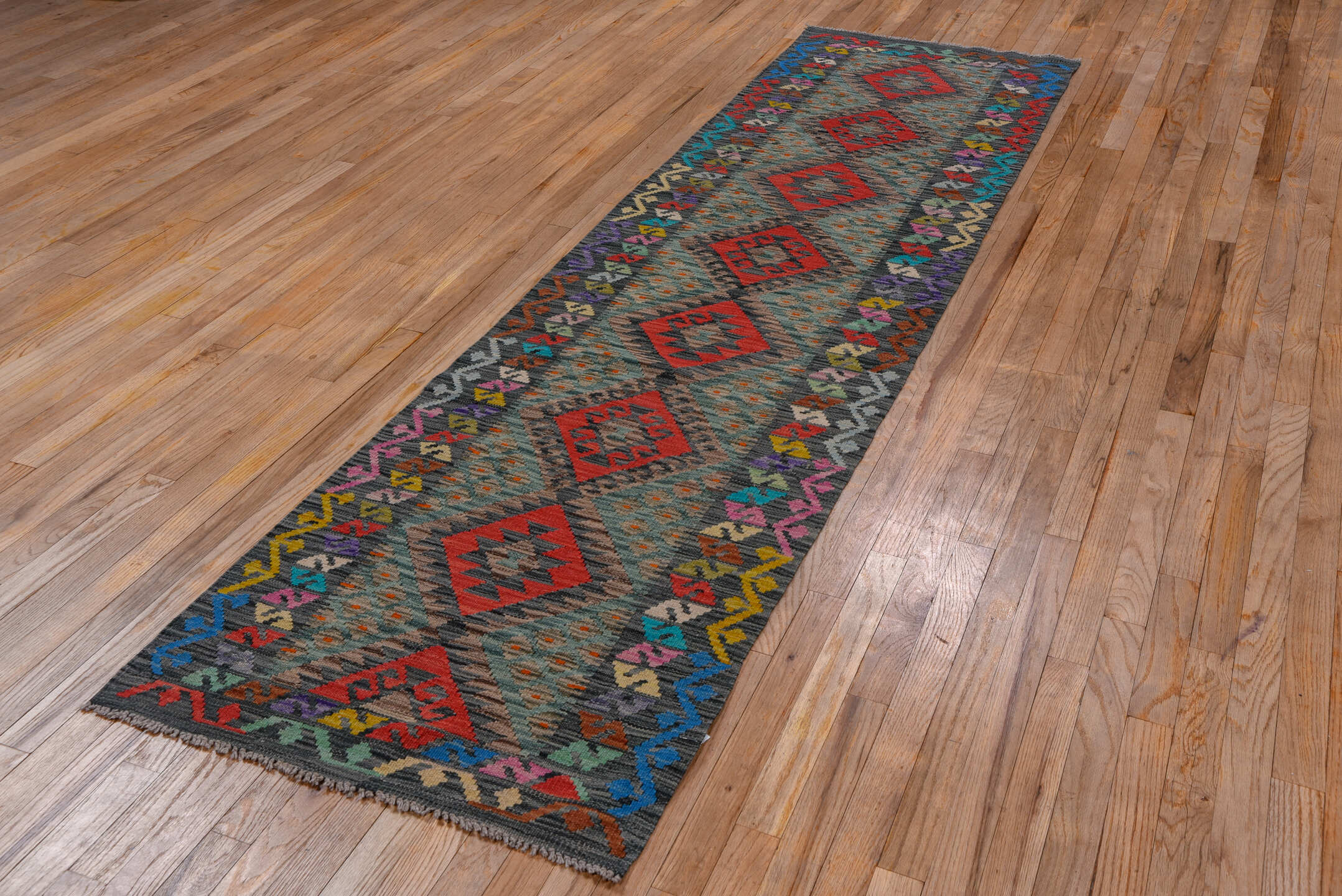 2' x 9' one-of-a-kind handmade vintage Kilim runner rug. Color palette: teal, charcoal, crimson, cobalt, taupe, lavender
