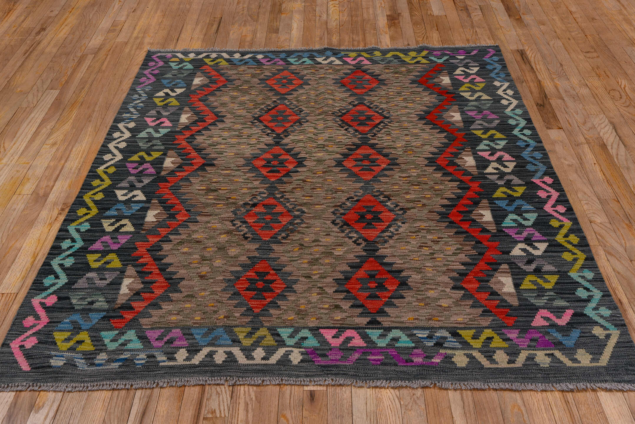5' x 6' one-of-a-kind handmade vintage Kilim rug. Color palette: taupe, charcoal, crimson, turquoise, gold, ivory, pink