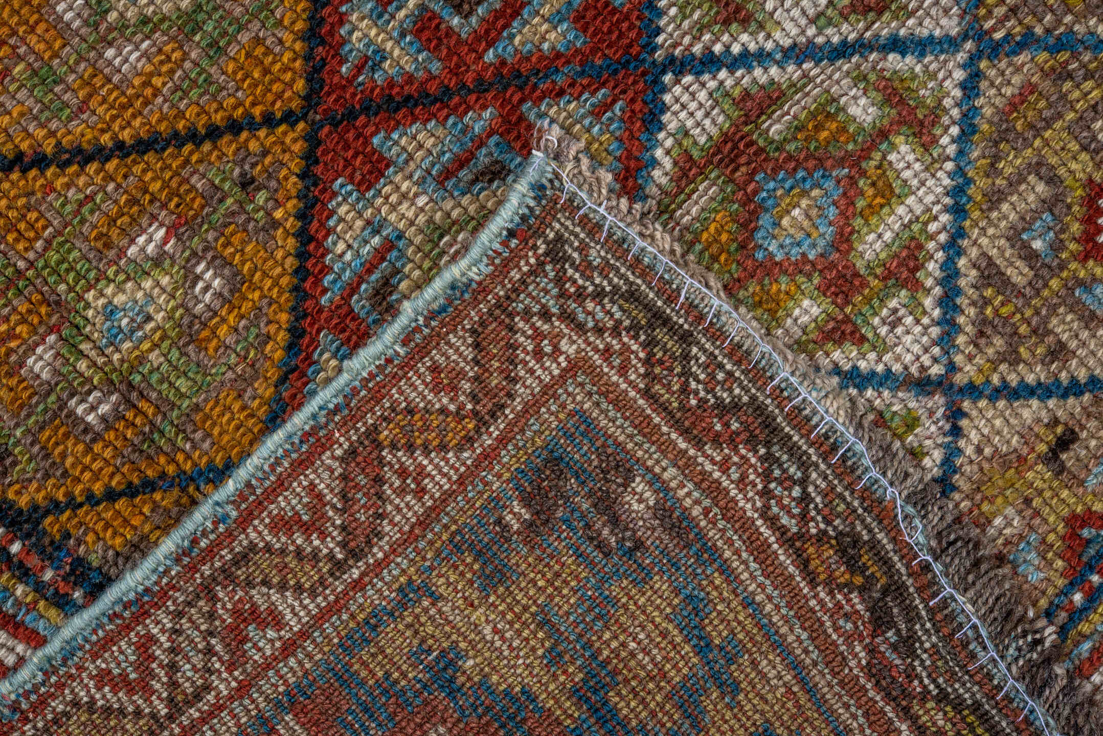 4' x 8' one-of-a-kind handmade antique Kurd rug. Color palette: camel, ivory, rust, sky blue, navy, taupe, gold, brown