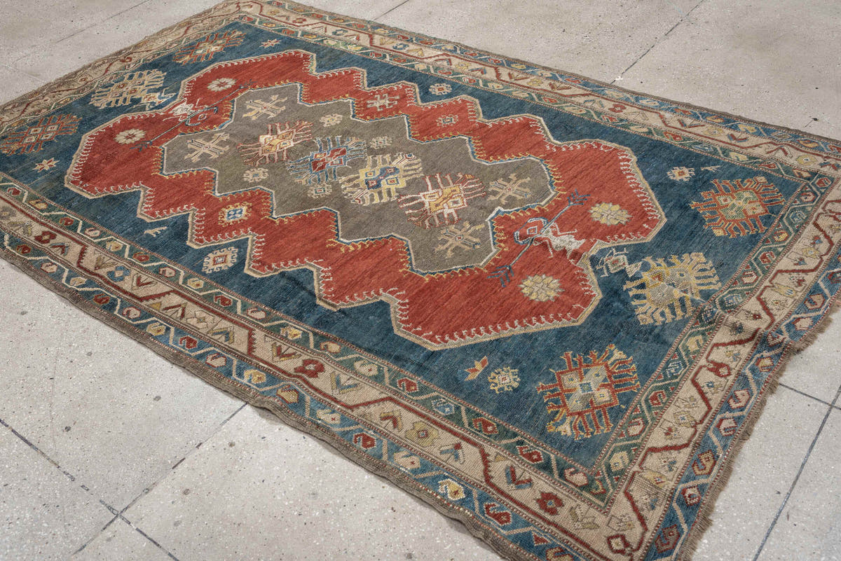 5' x 8' one-of-a-kind handmade antique Caucasian medium size rug. Color palette: teal, rust, ivory, taupe, terracotta, ochre