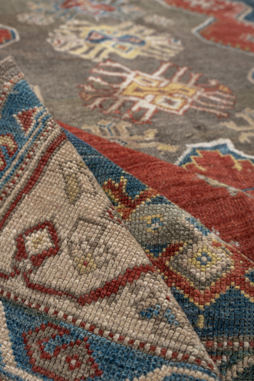 5' x 8' one-of-a-kind handmade antique Caucasian medium size rug. Color palette: teal, rust, ivory, taupe, terracotta, ochre