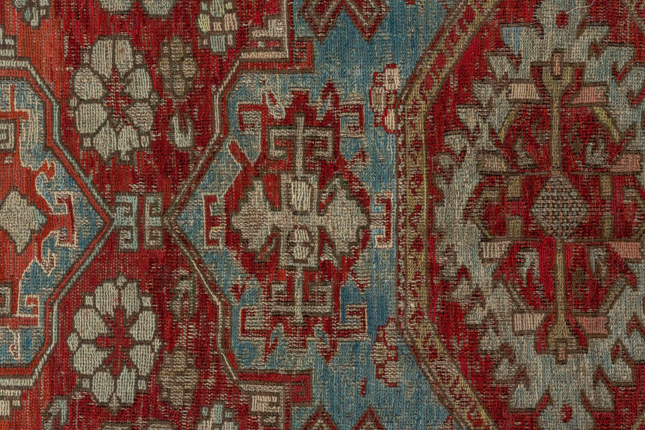 7' x 9' one-of-a-kind handmade antique Sumak rug. Color palette: rust, sky blue, ivory, beige, gold, brick, taupe