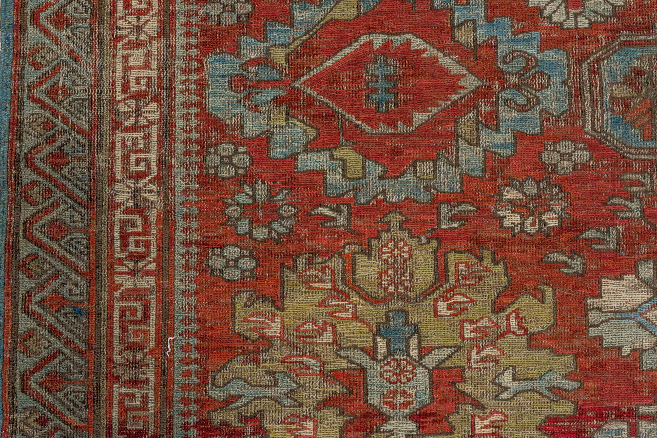 7' x 9' one-of-a-kind handmade antique Sumak rug. Color palette: rust, sky blue, ivory, beige, gold, brick, taupe