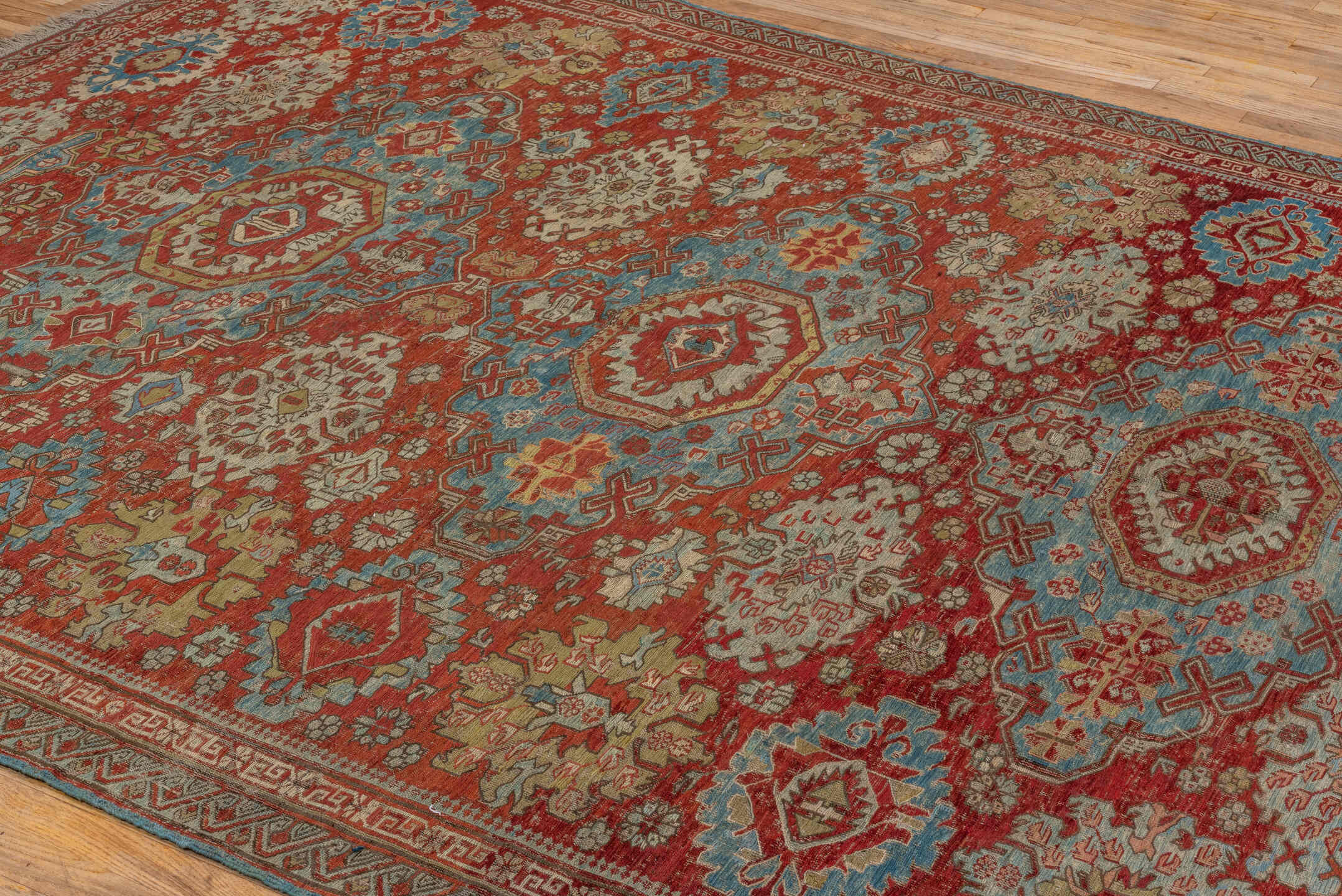 7' x 9' one-of-a-kind handmade antique Sumak rug. Color palette: rust, sky blue, ivory, beige, gold, brick, taupe