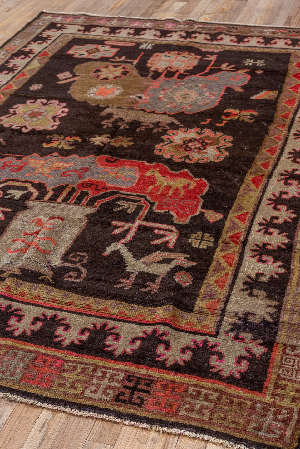 5' x 8' one-of-a-kind handmade antique Khotan medium size rug. Color palette: charcoal, camel, ivory, rose, rust, taupe