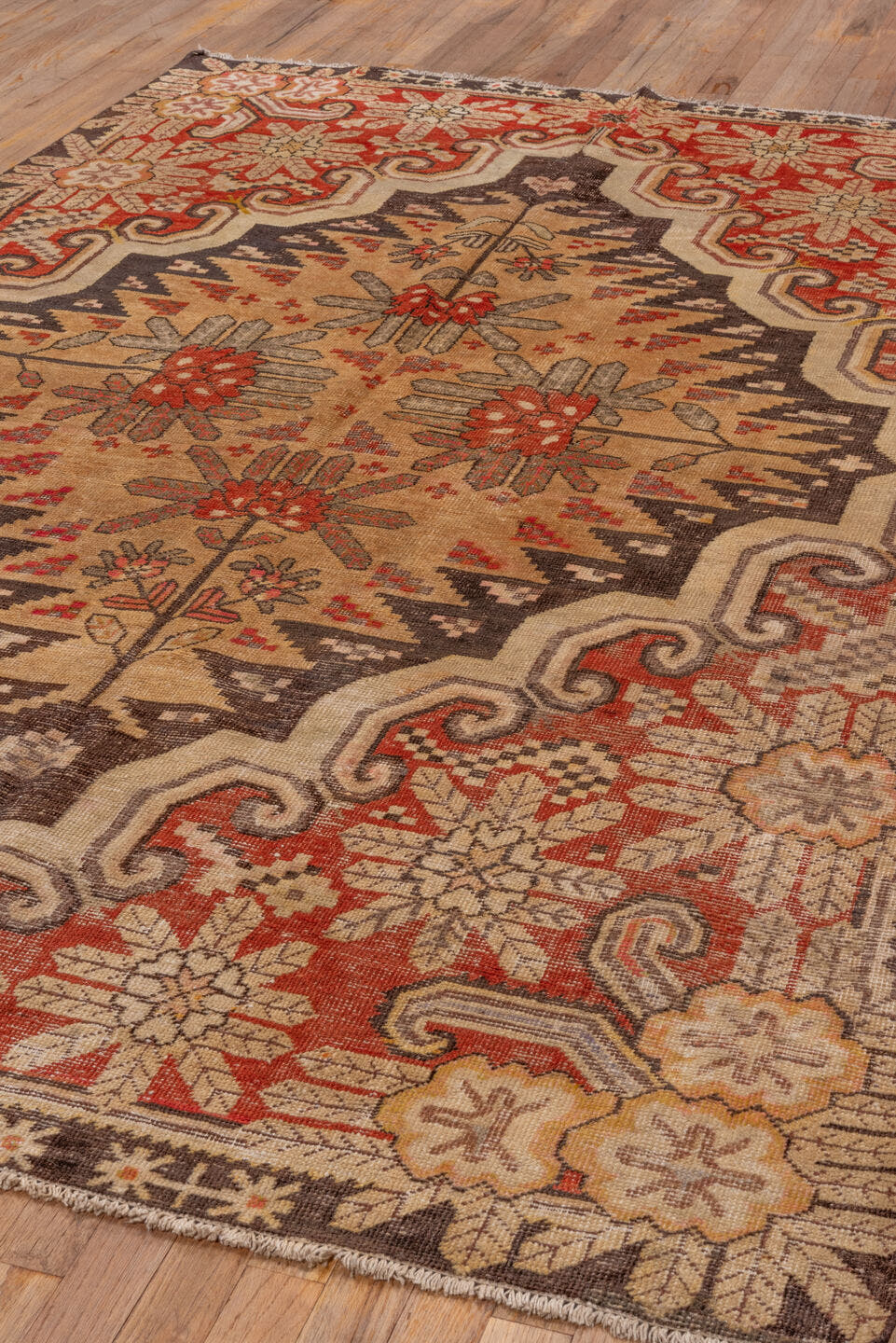 5' x 8' one-of-a-kind handmade antique Khotan medium size rug. Color palette: camel, rust, ivory, brown, terra cotta, taupe