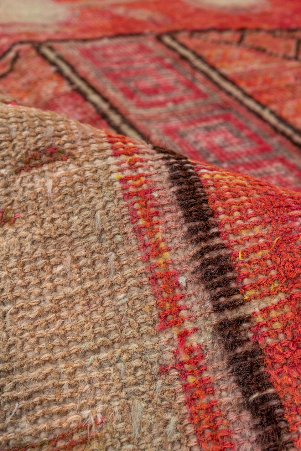 5' x 10' one-of-a-kind handmade vintage Khotan runner rug. Color palette: brown, fire brick, light coral, off-white, pink