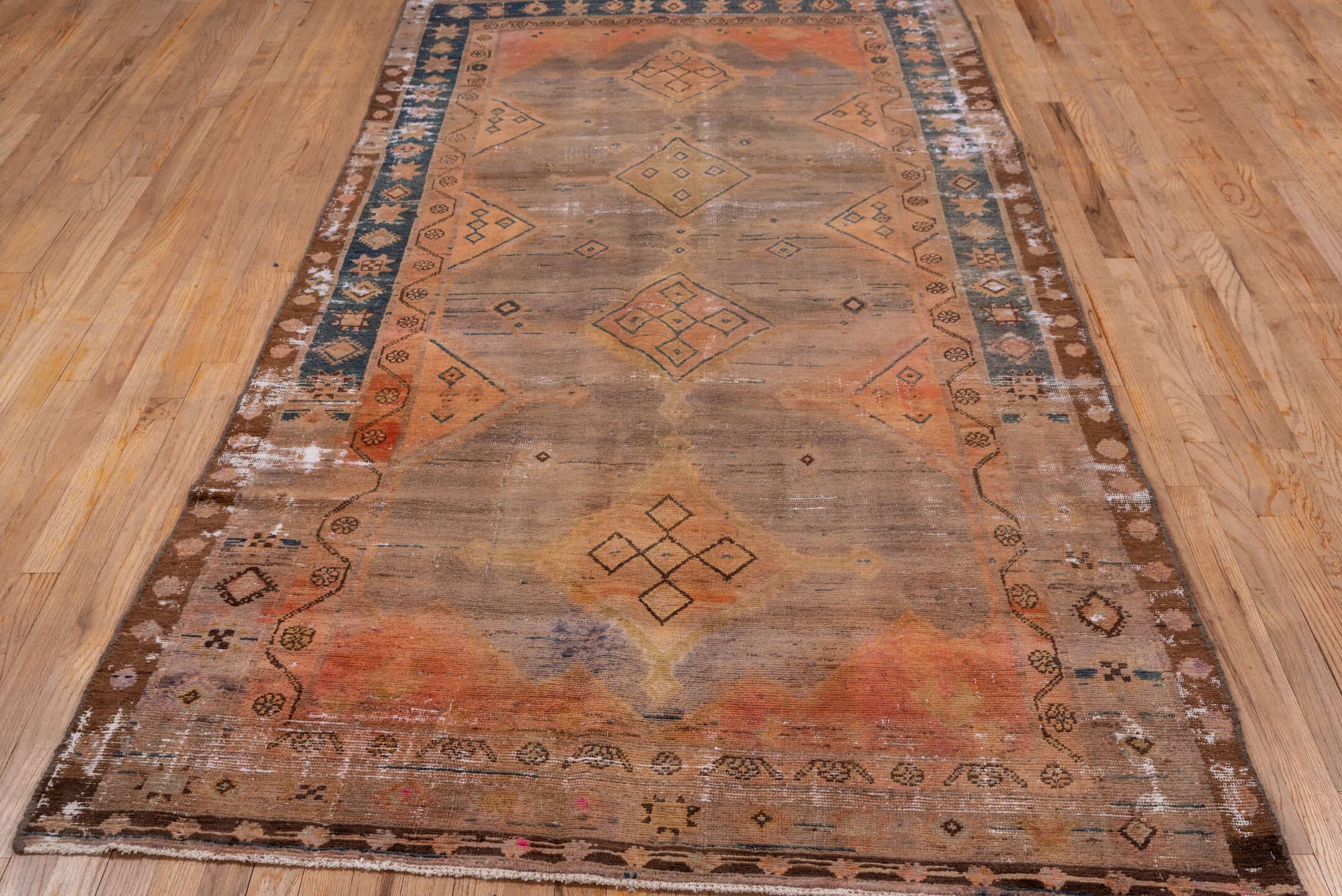 4' x 9' one-of-a-kind handmade vintage Distressed runner rug. Color palette: taupe, terra cotta, brown, charcoal, camel