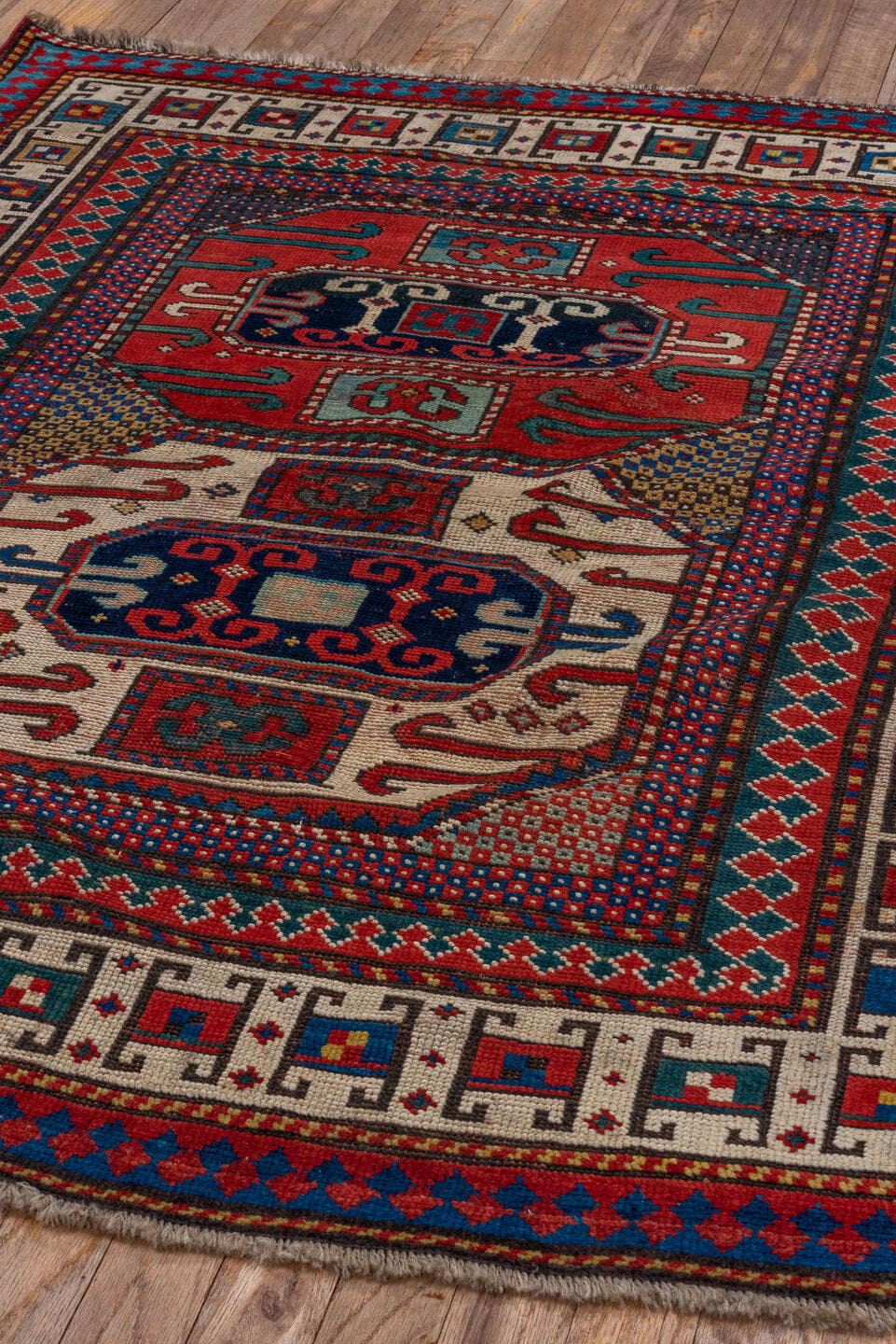 4' x 4' one-of-a-kind handmade antique Kazak small size rug. Color palette: ivory, red, navy, cobalt, teal, crimson, camel