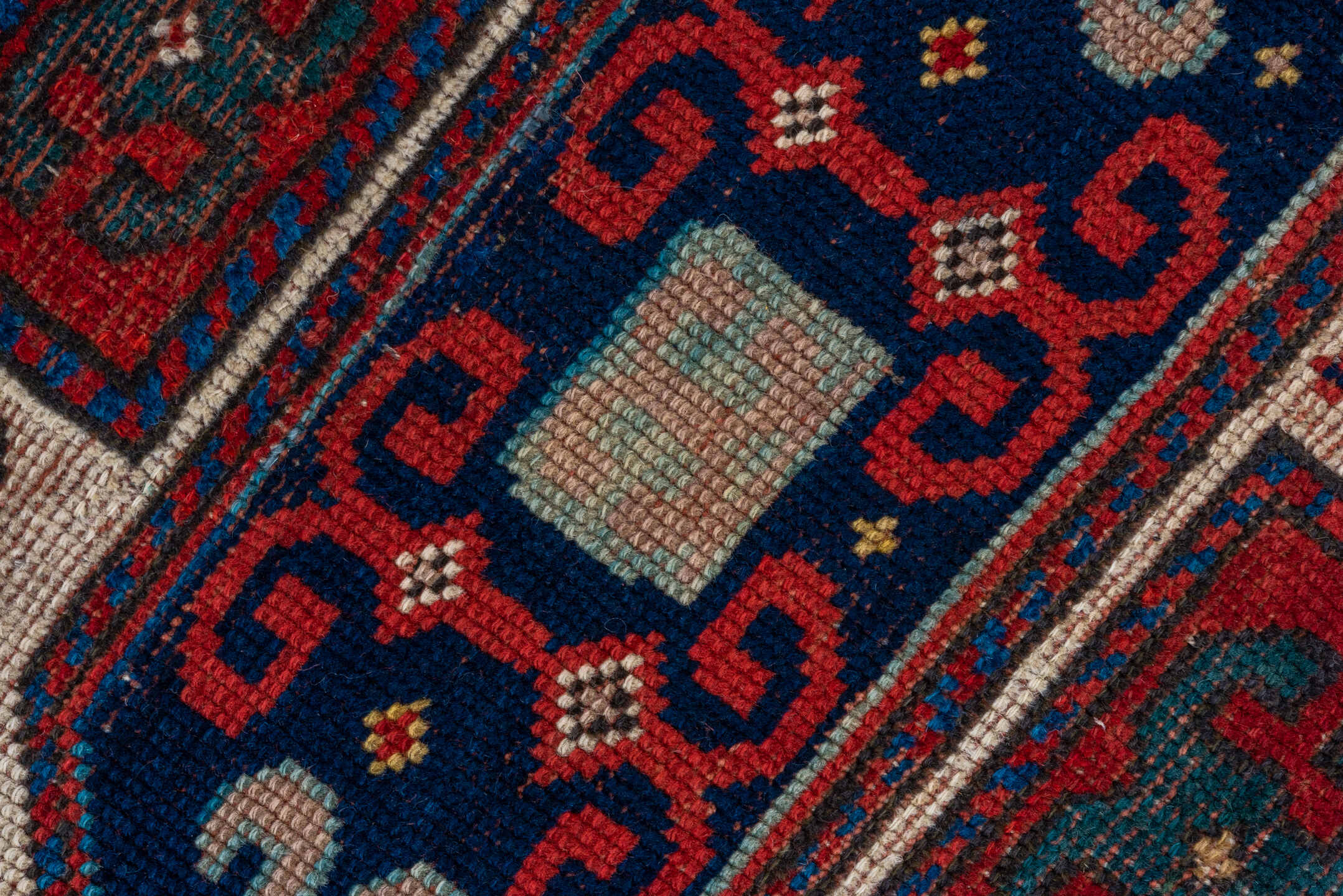 4' x 4' one-of-a-kind handmade antique Kazak small size rug. Color palette: ivory, red, navy, cobalt, teal, crimson, camel