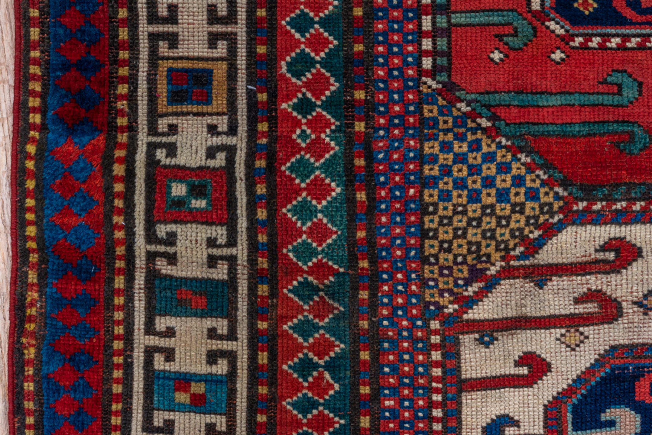4' x 4' one-of-a-kind handmade antique Kazak small size rug. Color palette: ivory, red, navy, cobalt, teal, crimson, camel