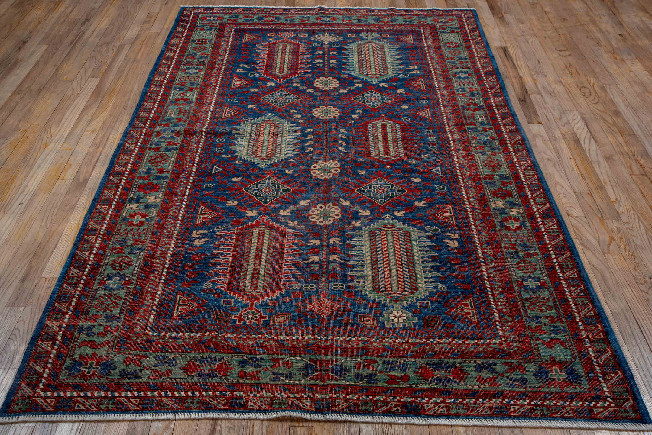 5' x 8' one-of-a-kind handmade vintage Shirvan medium size rug. Color palette: blue, brown, gray, pink, red, redwood