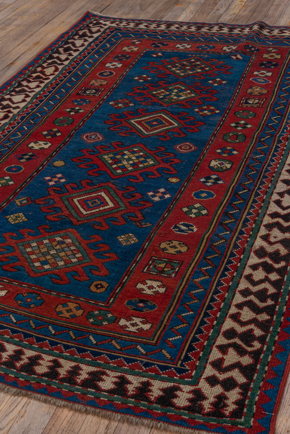3' x 6' one-of-a-kind handmade antique Kazak small size rug. Color palette: blue, rust, ivory, navy, crimson, gold, teal