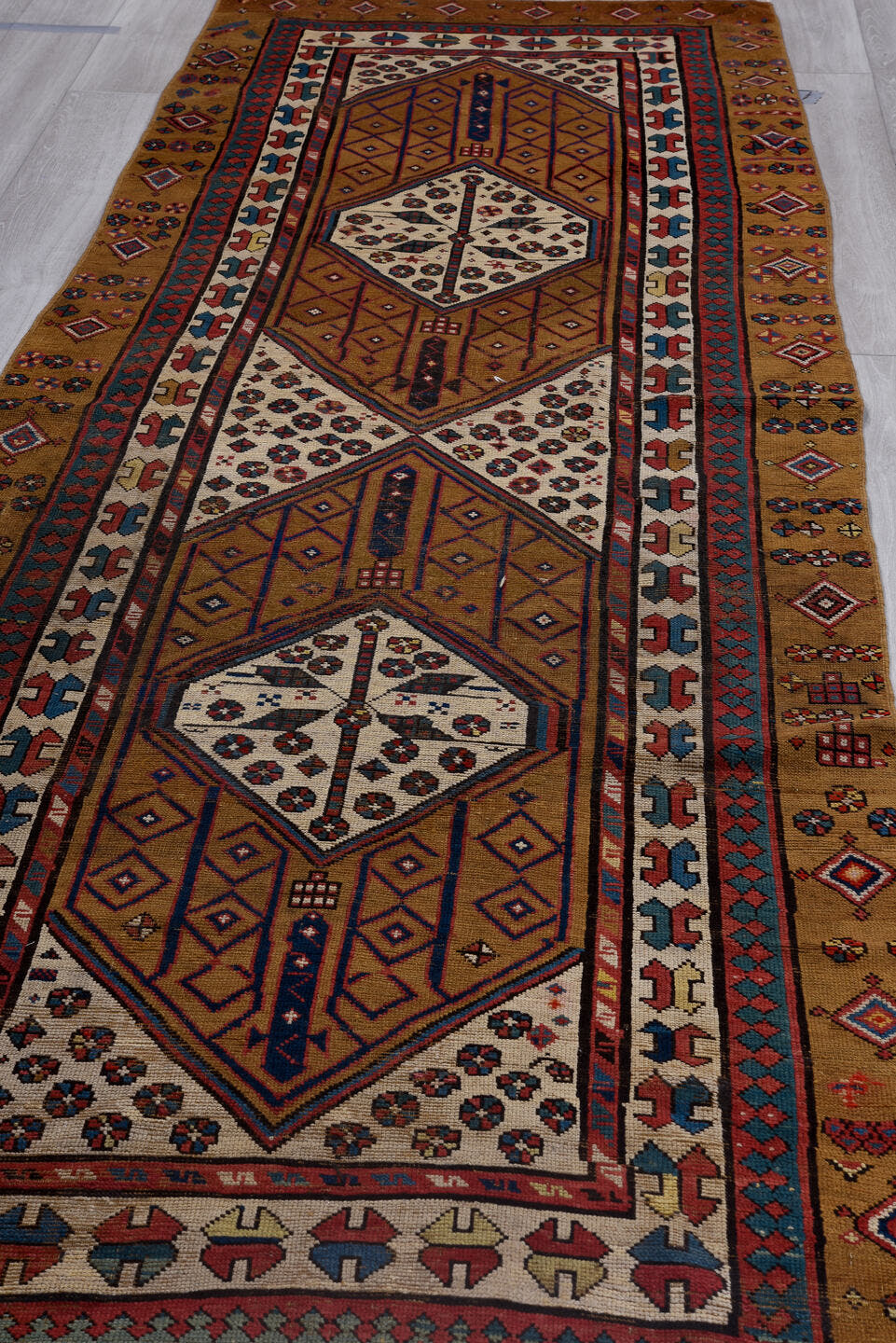 3' x 12' one-of-a-kind handmade antique Sarab runner rug. Color palette: camel, ivory, rust, navy, brick, sky_blue, brown