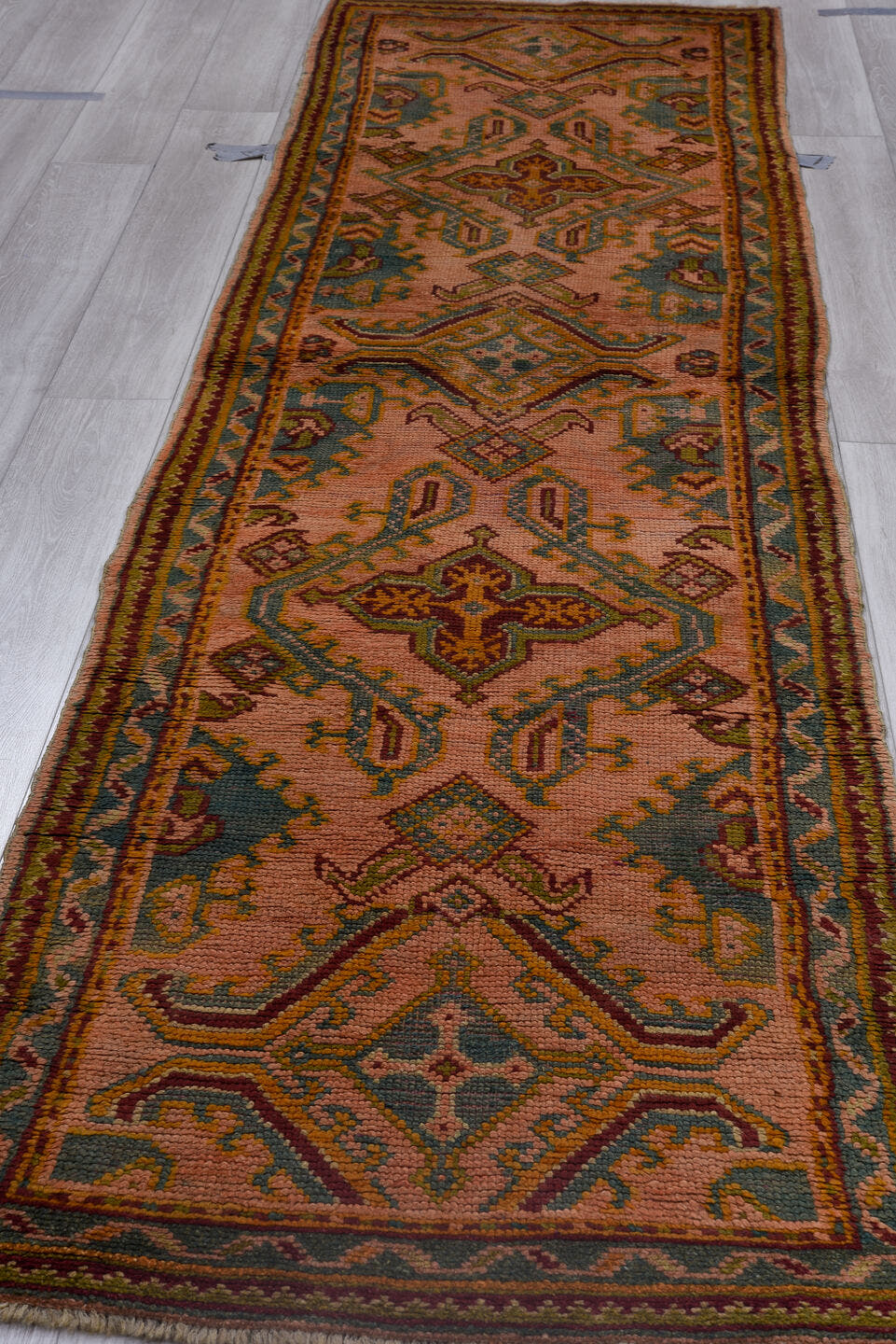 3' x 11' one-of-a-kind handmade antique Oushak runner rug. Color palette: rose, rust, sage, gold, teal, burgundy, ivory