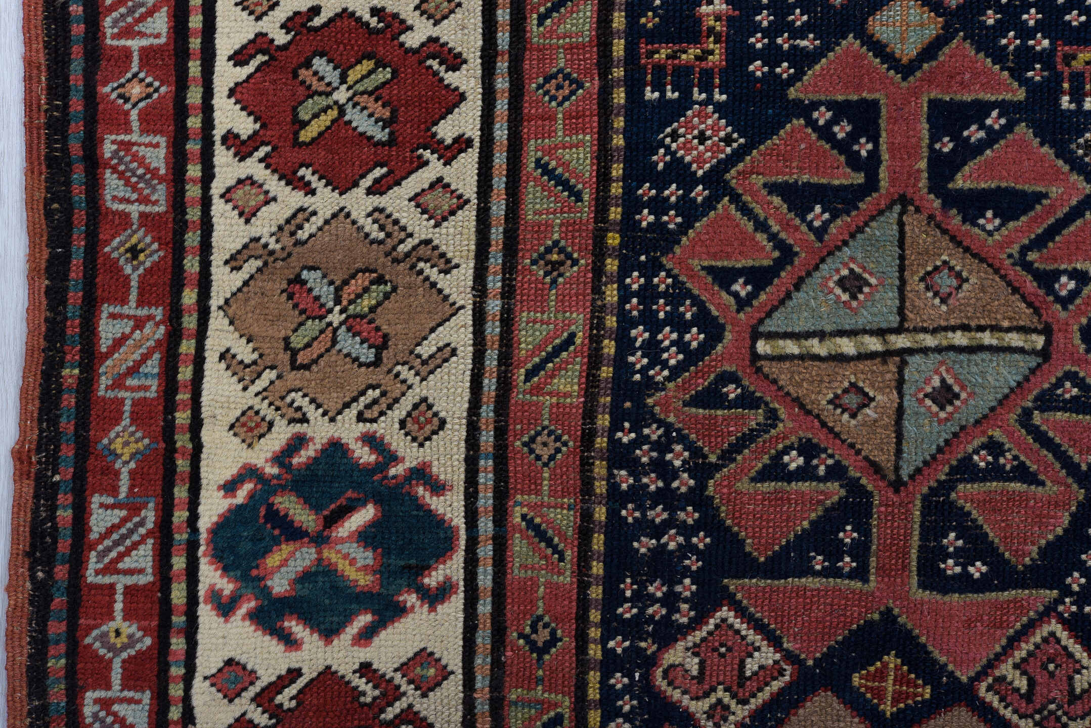 3' x 11' one-of-a-kind handmade vintage Caucasian runner rug. Color palette: navy, ivory, rust, rose, soft blue, taupe