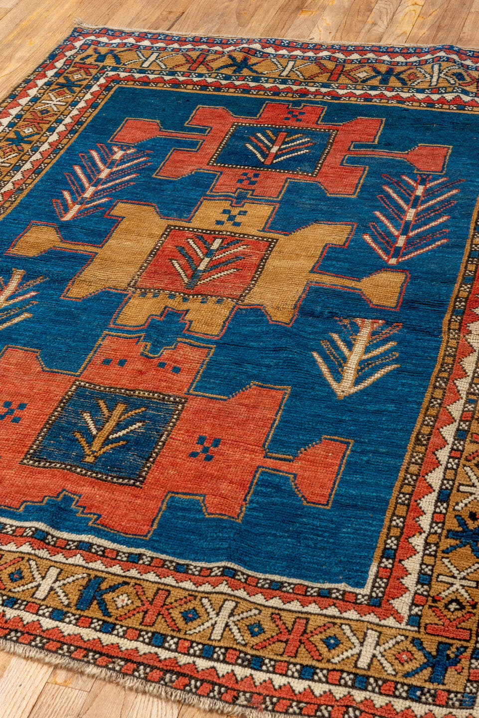 4' x 5' one-of-a-kind handmade antique Kazak small size rug. Color palette: blue, ivory, rust, navy, camel, coral