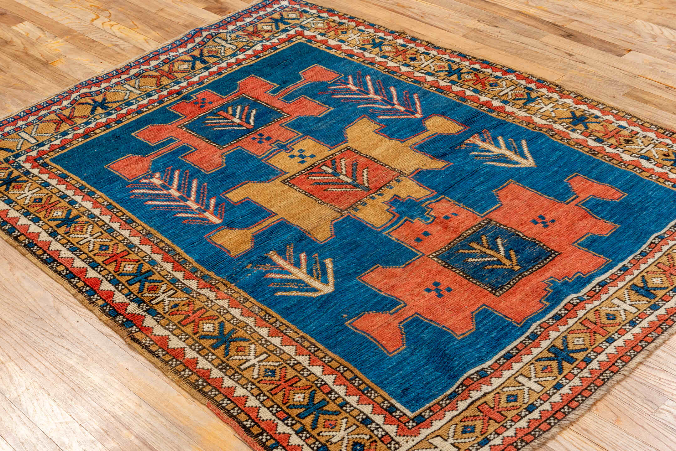 4' x 5' one-of-a-kind handmade antique Kazak small size rug. Color palette: blue, ivory, rust, navy, camel, coral