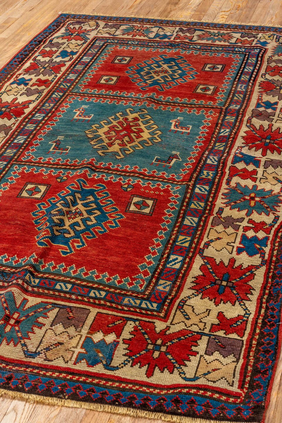 4' x 7' one-of-a-kind handmade antique Kazak rug. Color palette: ivory, red, sky blue, navy, rust, taupe, teal, light blue