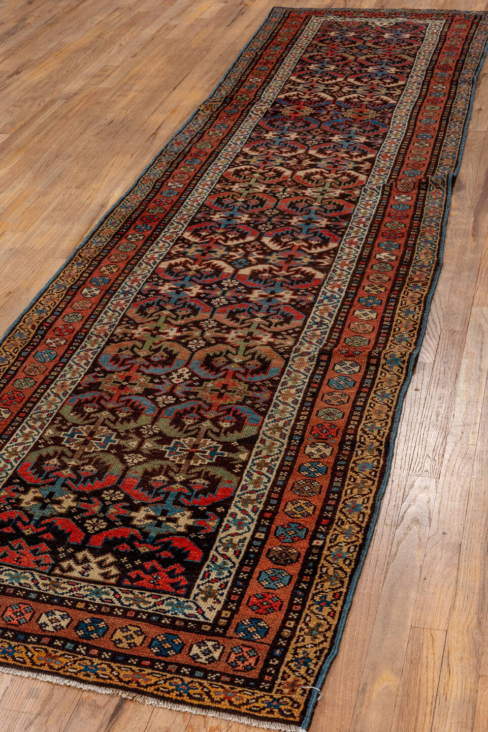 2' x 12' one-of-a-kind handmade antique NW Persian runner rug. Color palette: brown, rust, navy, ivory, camel, indigo
