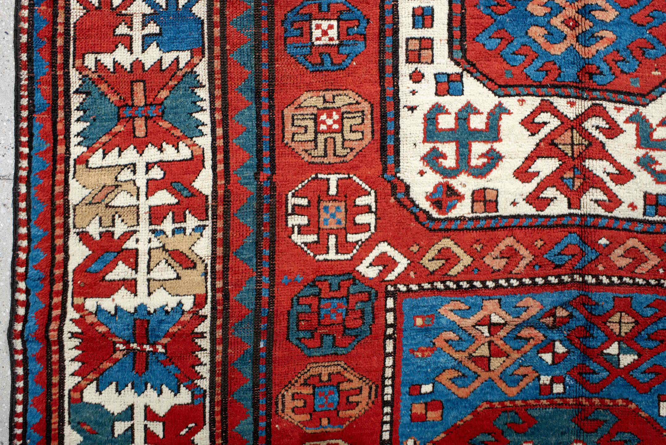5' x 10' one-of-a-kind handmade antique Kazak medium size rug. Color palette: red, ivory, blue, teal, navy, rust, cream