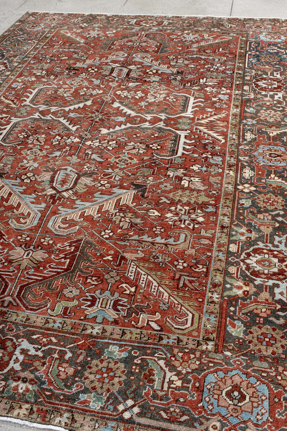 7' x 10' one-of-a-kind handmade antique Heriz large size rug. Color palette: rust, charcoal, ivory, sky_blue, sage, taupe