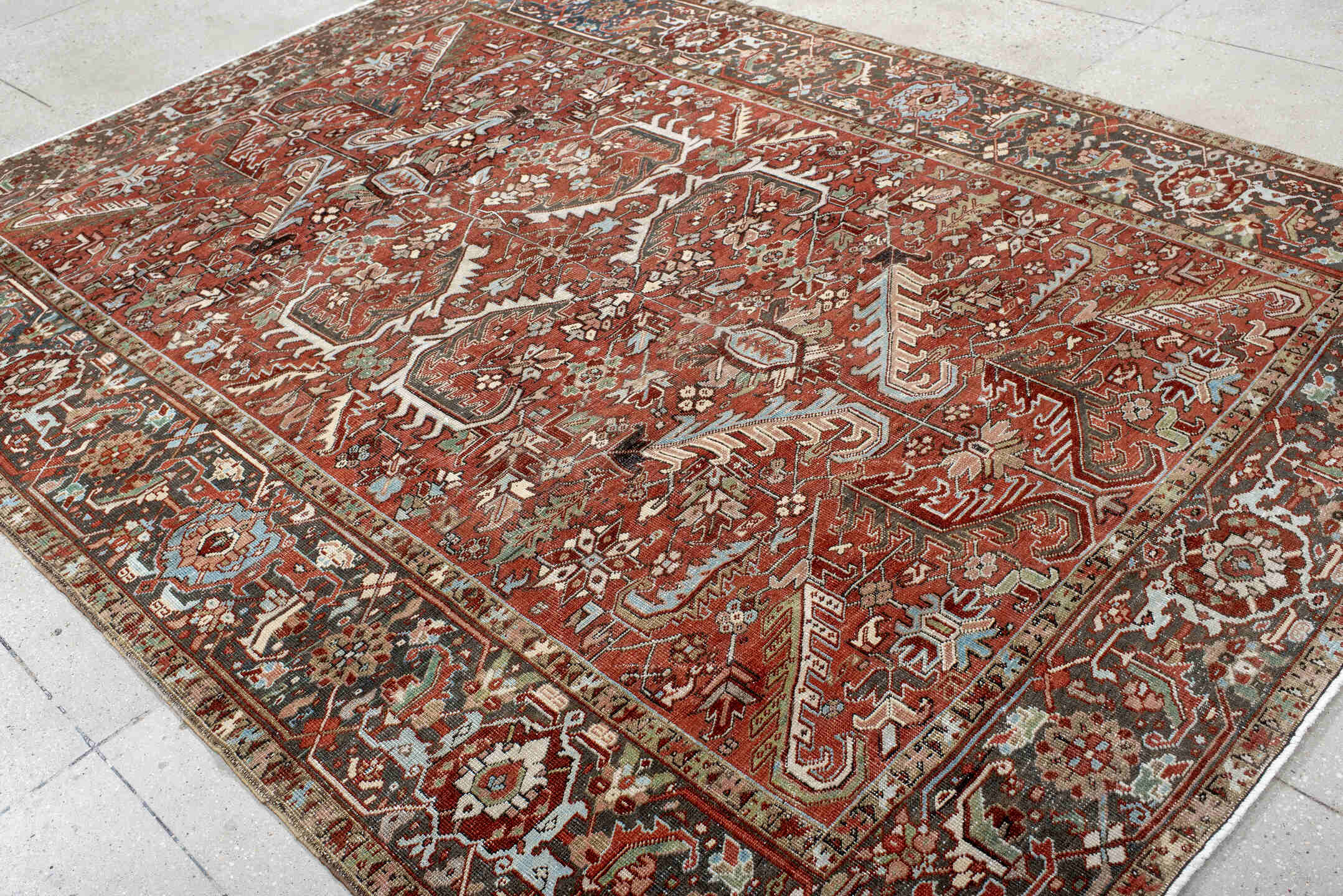 7' x 10' one-of-a-kind handmade antique Heriz large size rug. Color palette: rust, charcoal, ivory, sky_blue, sage, taupe