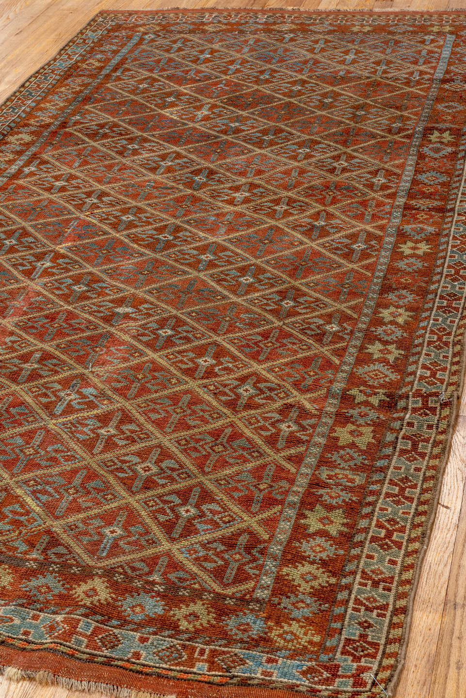 4' x 8' one-of-a-kind handmade antique Kurd rug. Color palette: rust, camel, ivory, sky blue, brown, taupe, gold, terracotta