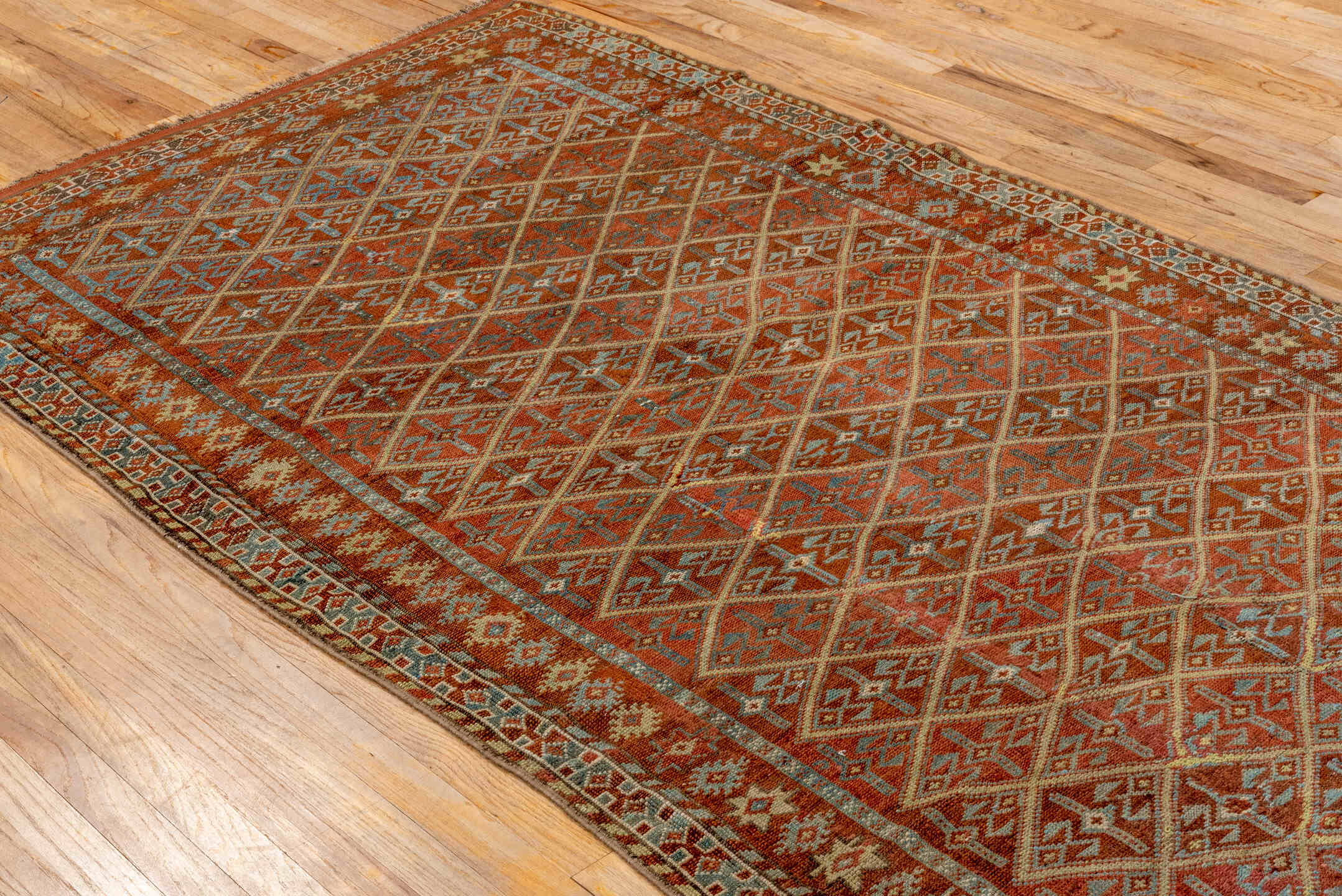 4' x 8' one-of-a-kind handmade antique Kurd rug. Color palette: rust, camel, ivory, sky blue, brown, taupe, gold, terracotta