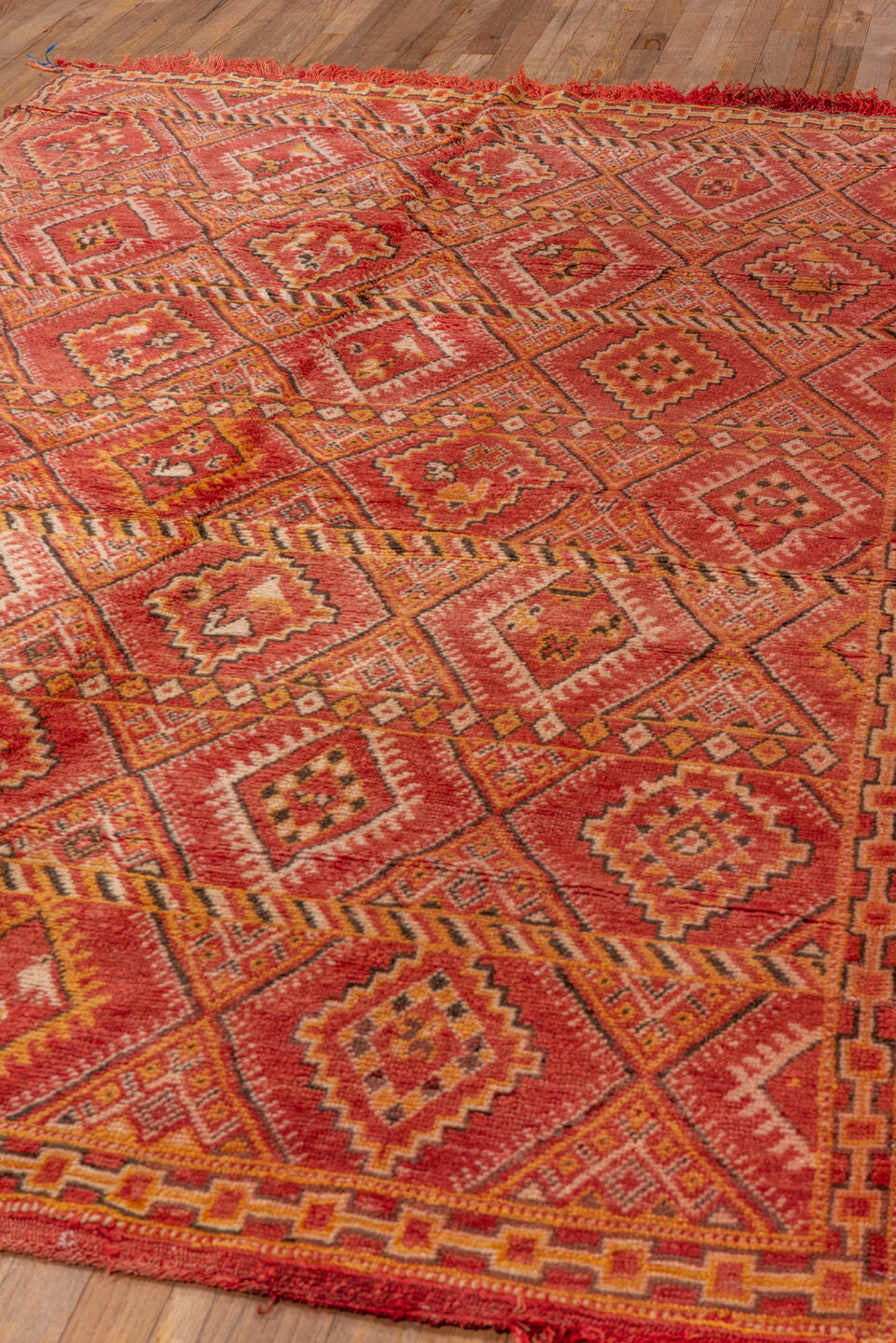 5' x 8' one-of-a-kind handmade vintage Moroccan medium size rug. Color palette: brown, dark red, orange, peru, pink, red