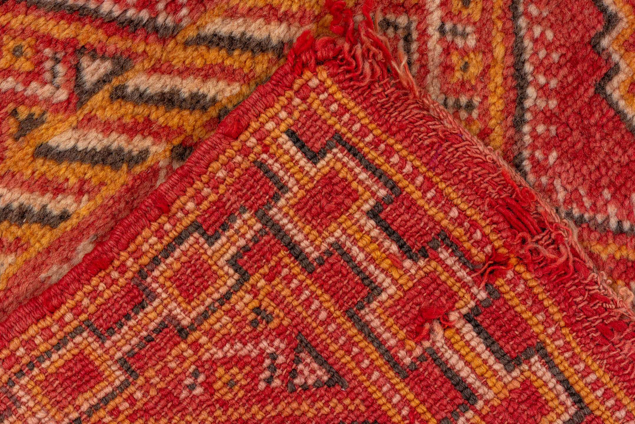 5' x 8' one-of-a-kind handmade vintage Moroccan medium size rug. Color palette: brown, dark red, orange, peru, pink, red