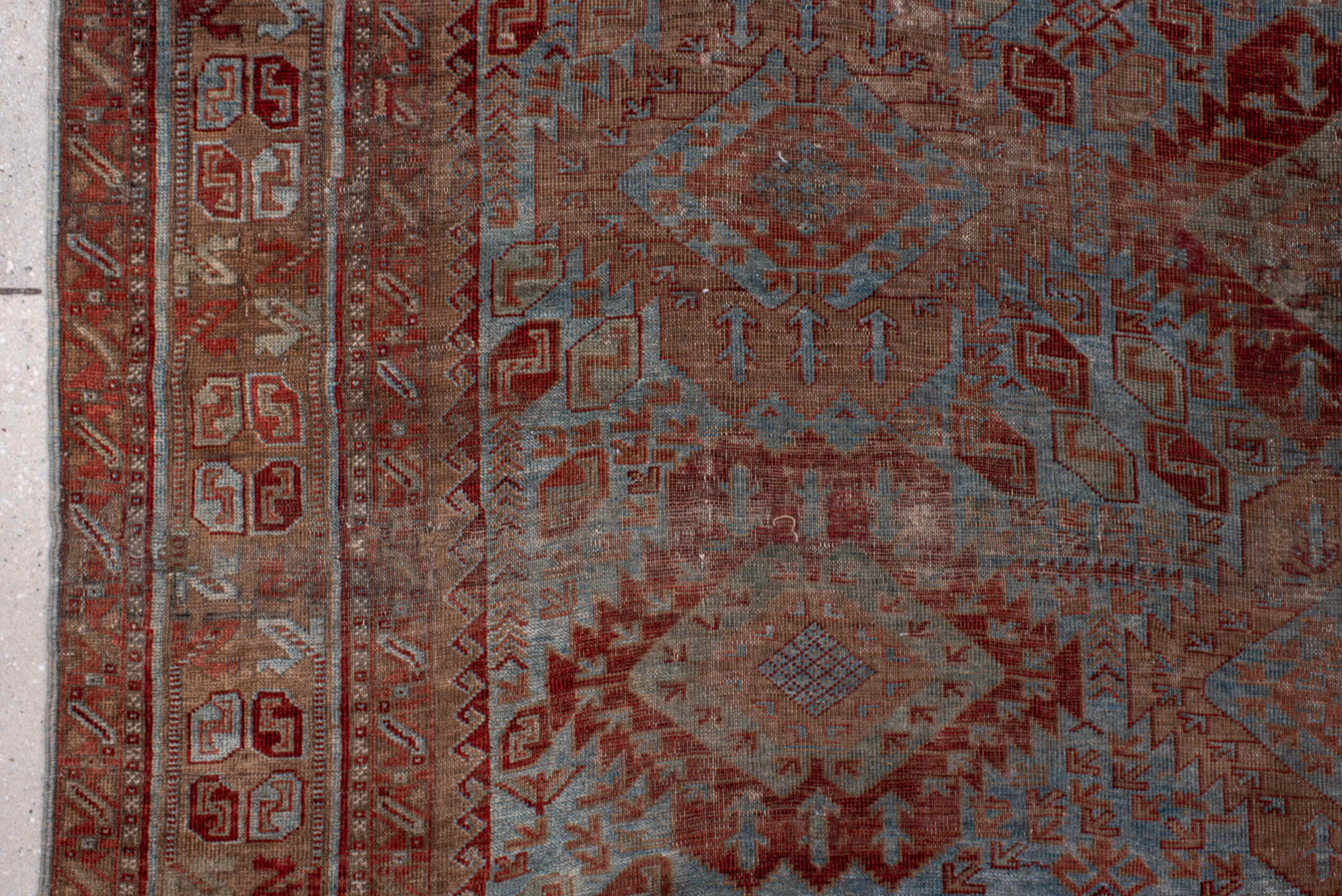 6' x 9' one-of-a-kind handmade antique Belouch rug. Color palette: rust, dusty blue, ivory, taupe, burgundy, brown