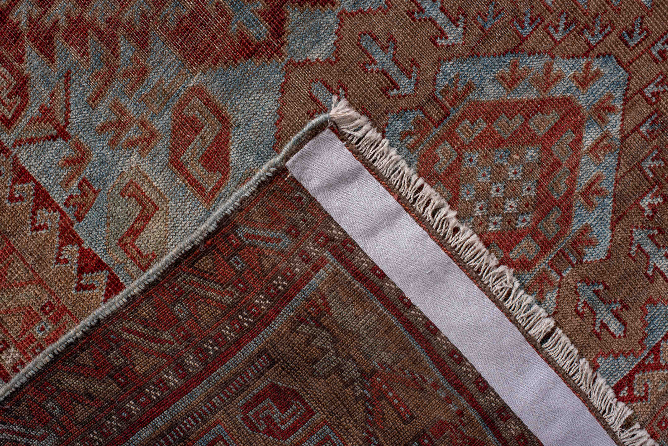 6' x 9' one-of-a-kind handmade antique Belouch rug. Color palette: rust, dusty blue, ivory, taupe, burgundy, brown